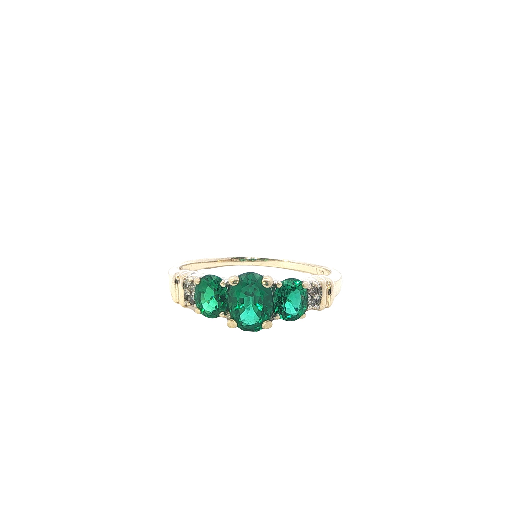 Gold ring with three green gemstones on a white background