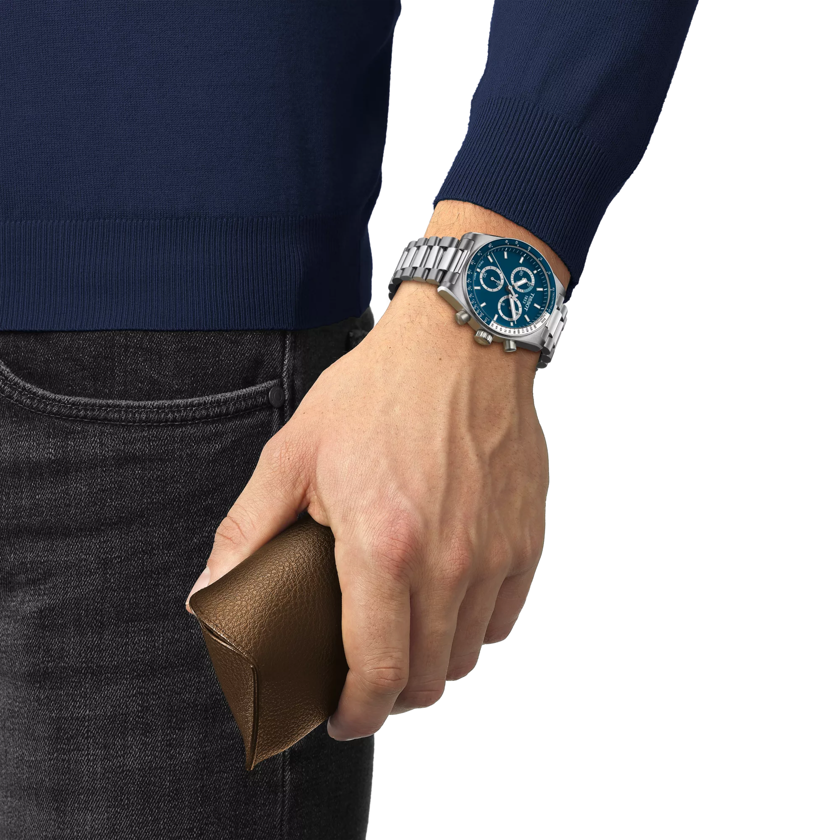 Hand wearing a silver watch with a blue face, holding a brown leather wallet, against a white background.