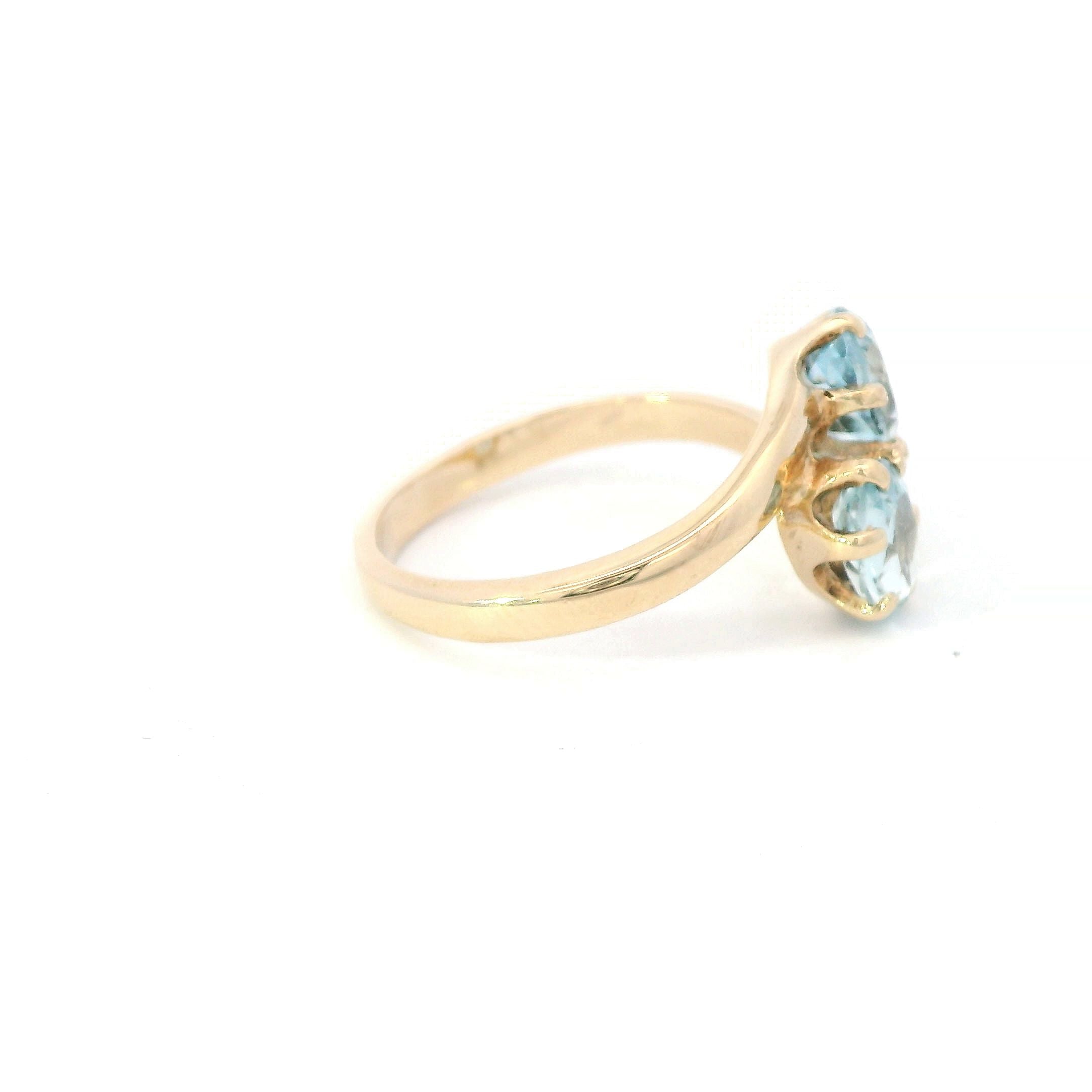 Estate Collection: 14K Yellow Gold 2-Stone Oval Aquamarine Bypass Ring