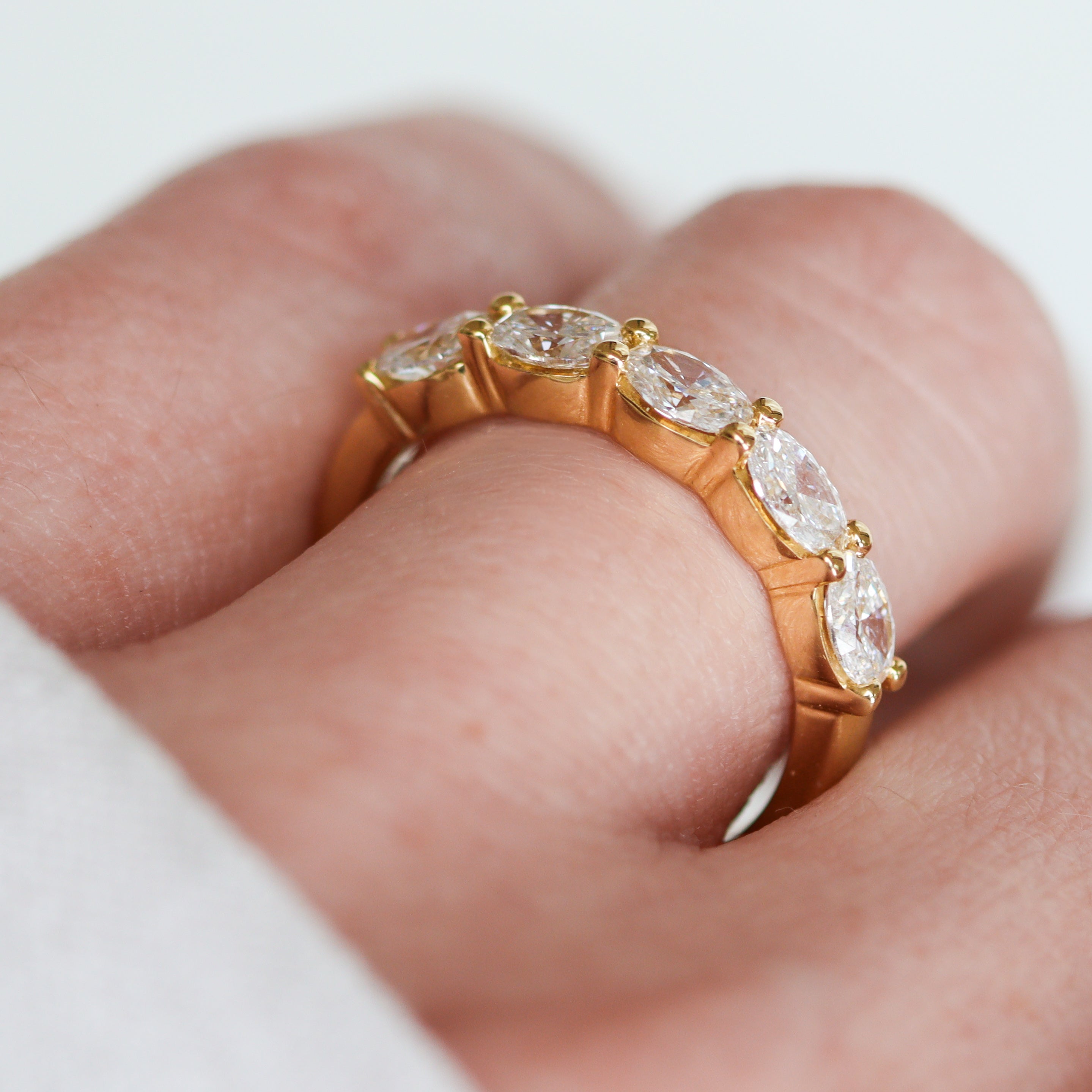 side view of 5-Stone oval ring on a finger