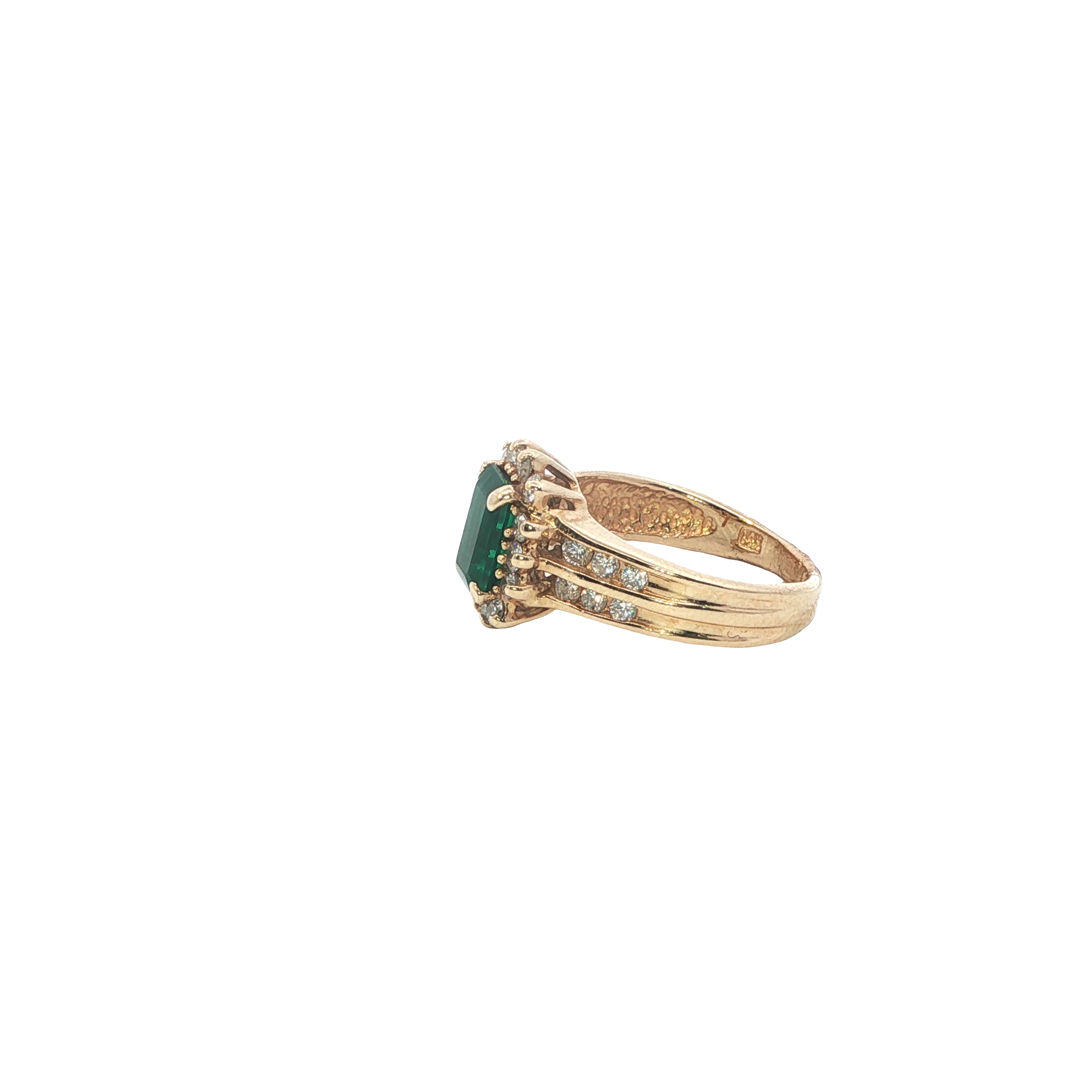 Gold ring with a green gemstone on a white background