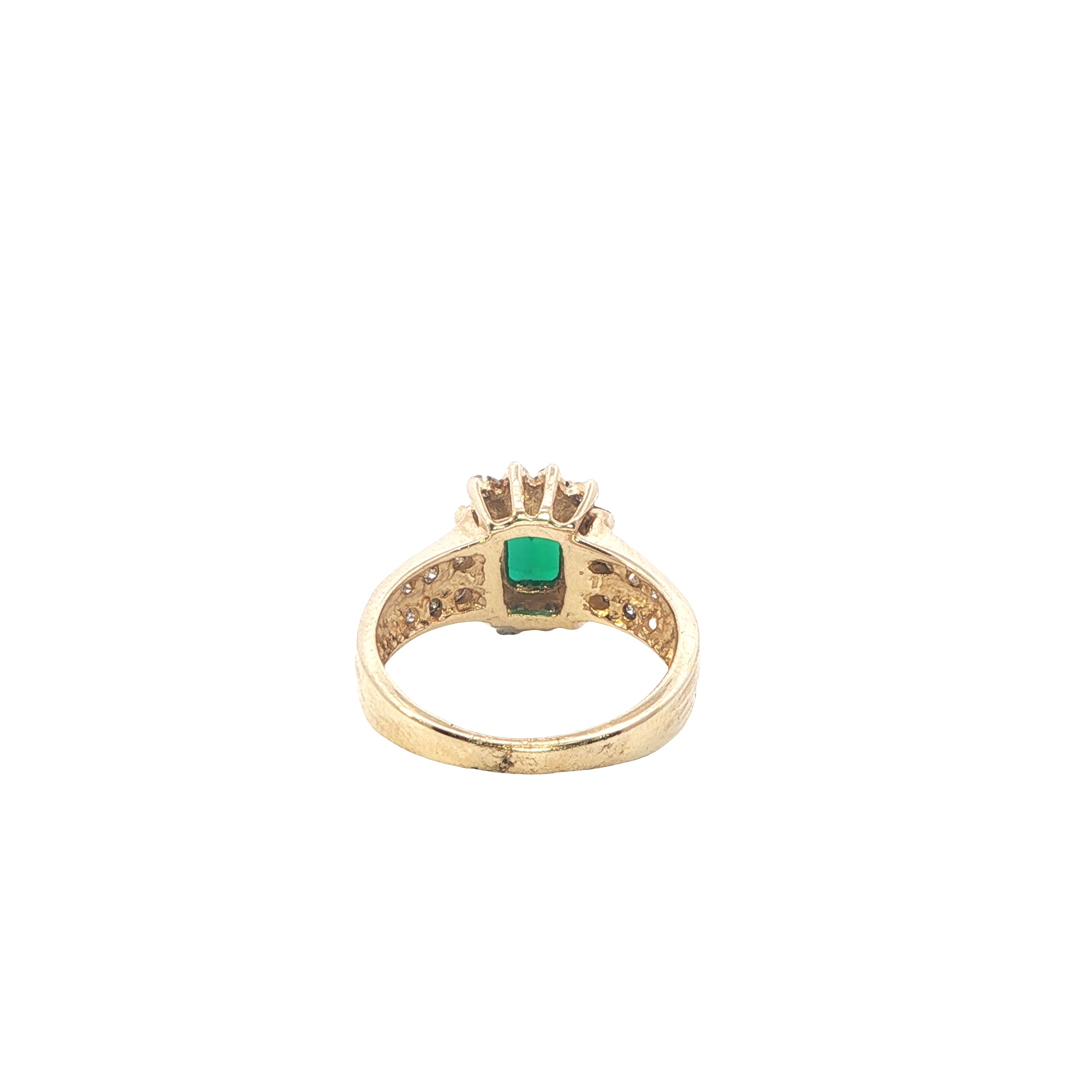 Gold ring with a green gemstone on a white background