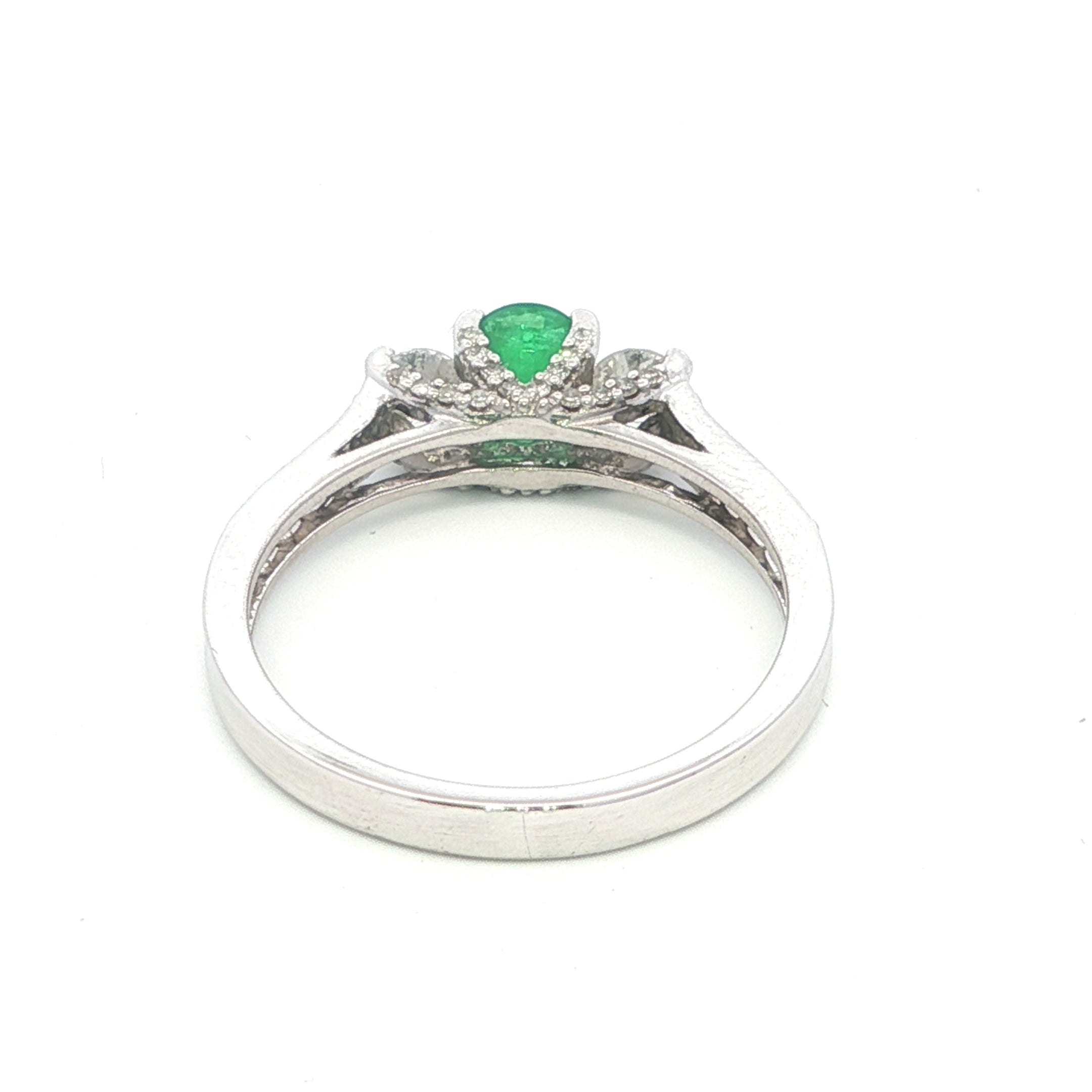 Silver ring with a green gemstone on a white background