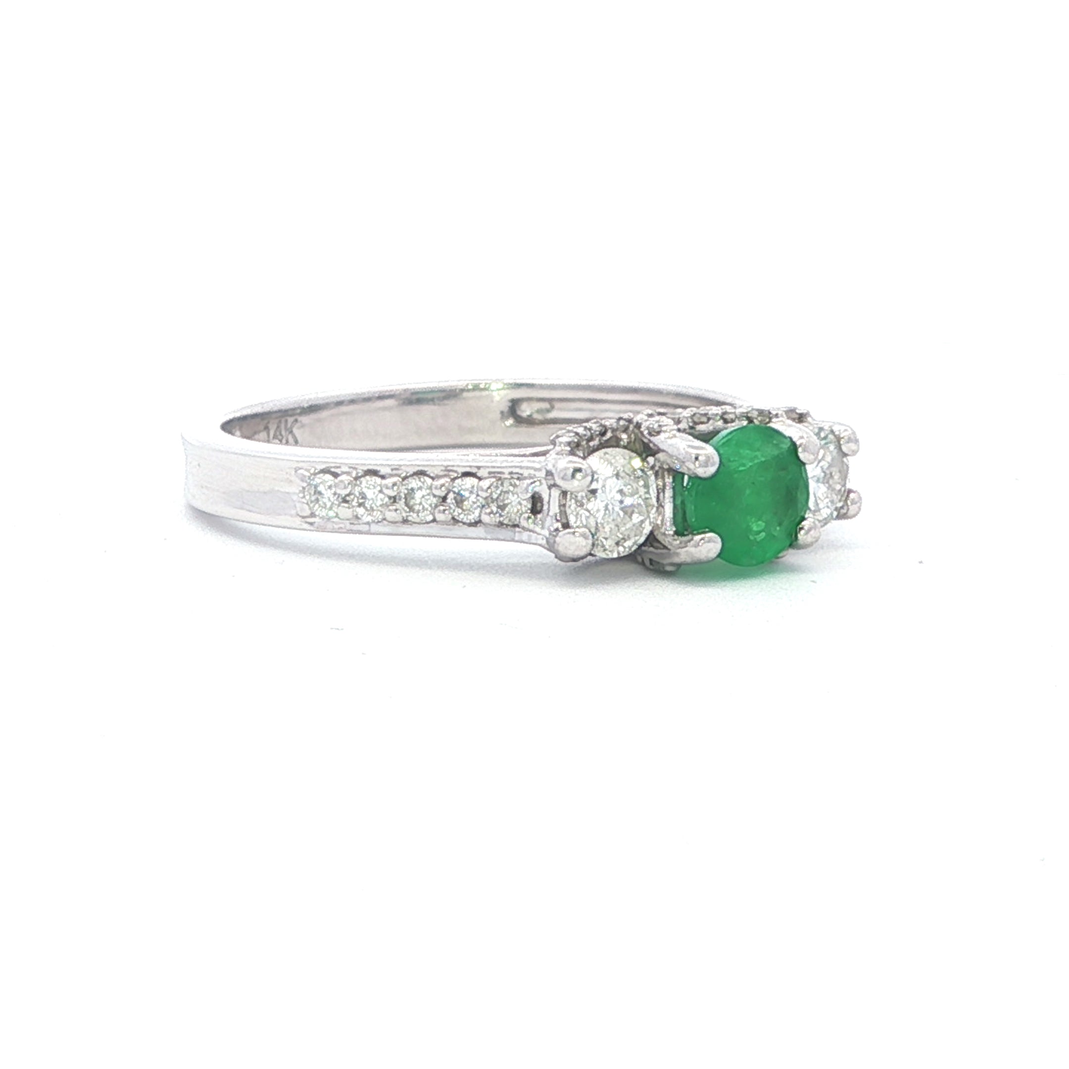 Silver ring with a green gemstone on a white background