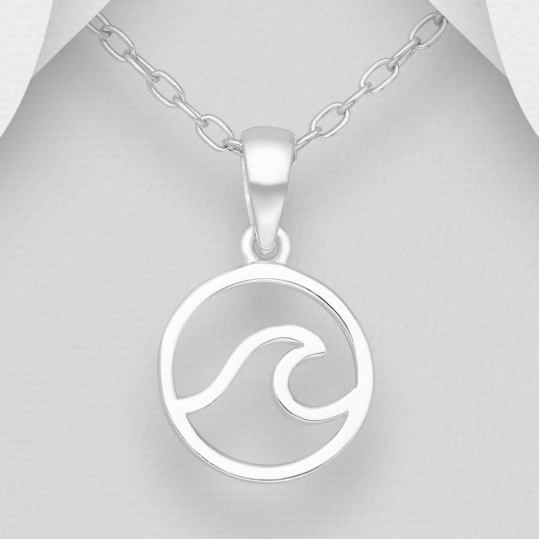 Silver necklace with a wave pendant on a mannequin.