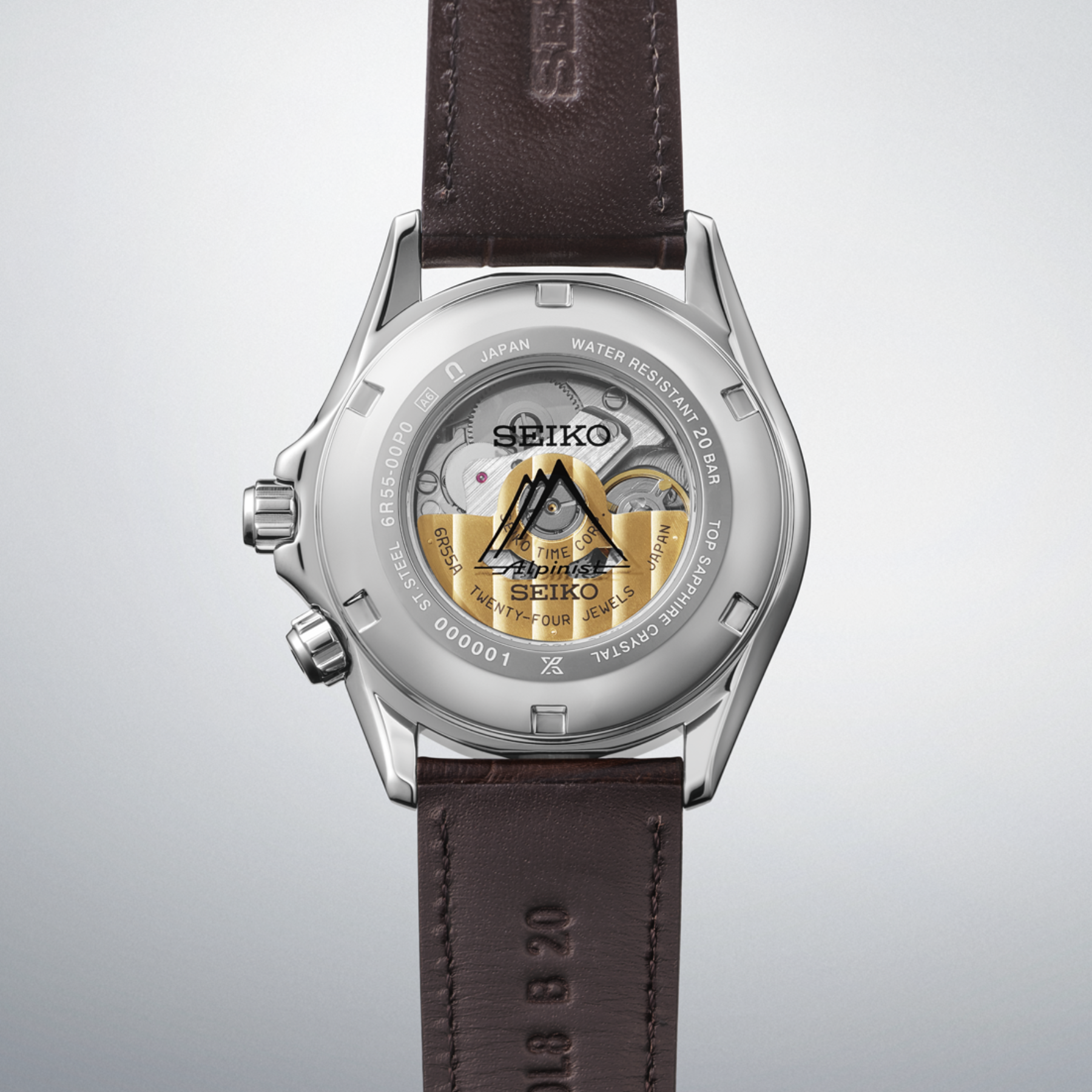 Seiko watch with brown leather strap on a light gray background