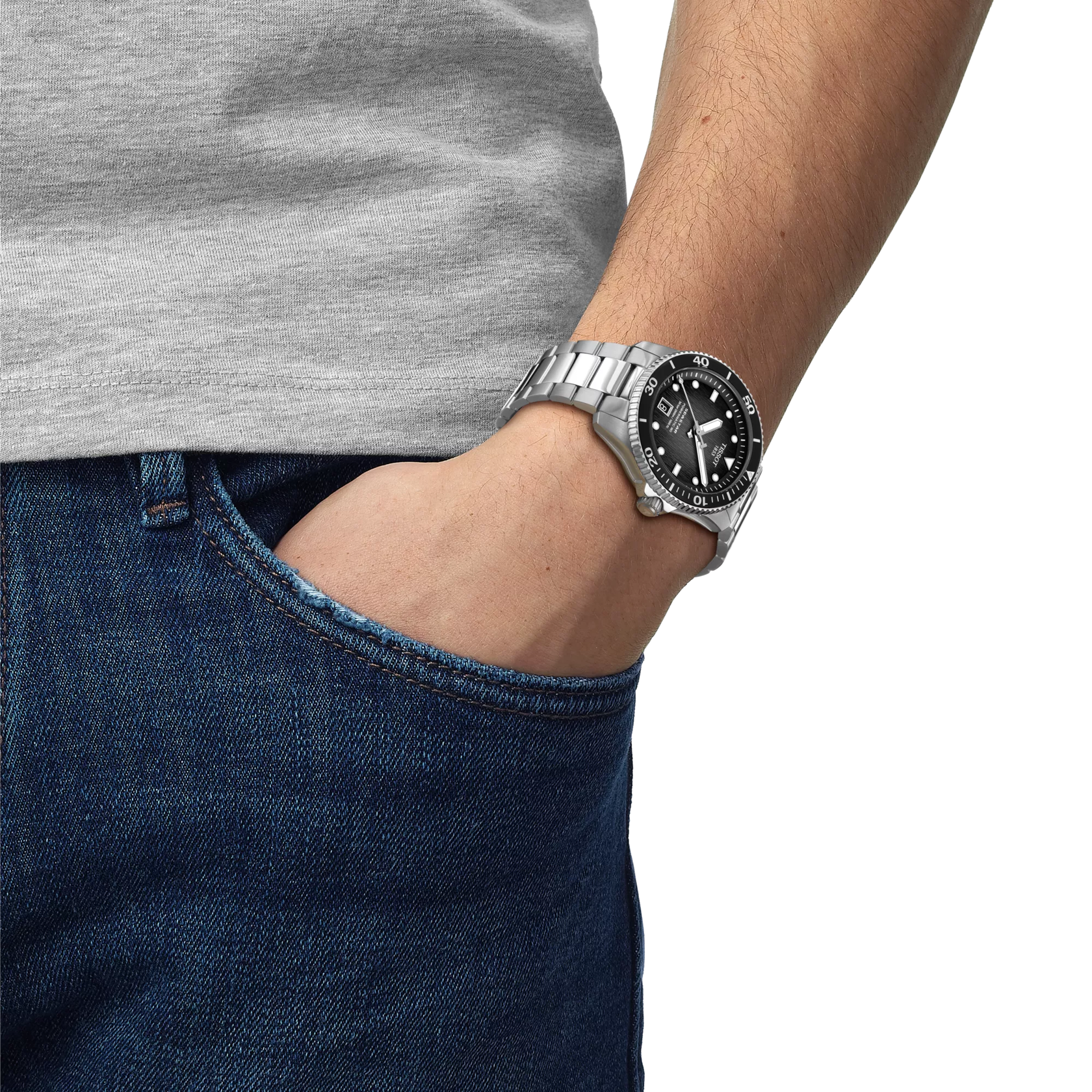 Person wearing a silver watch with a black face on a plain background