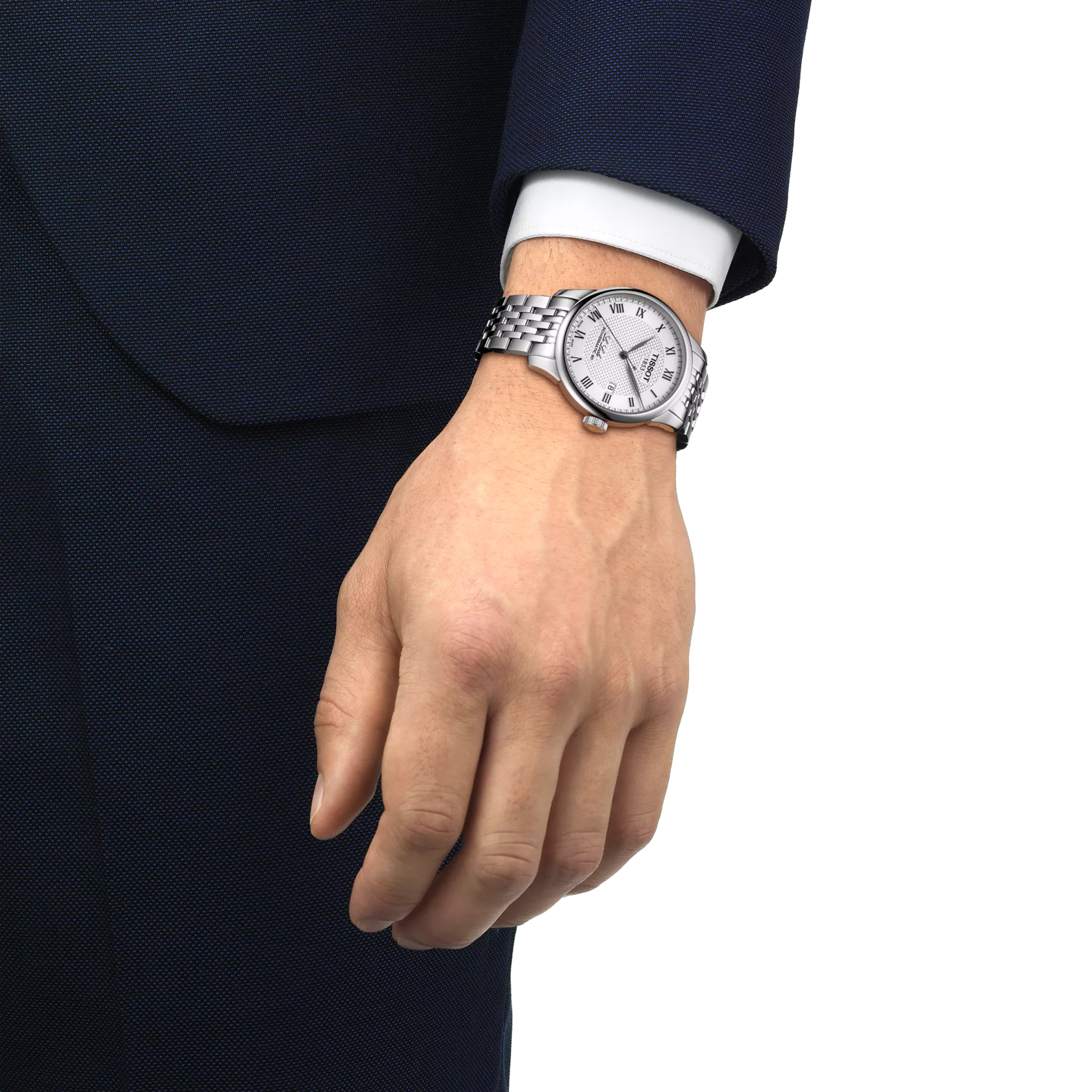 Hand wearing a silver watch with a white face on a white background