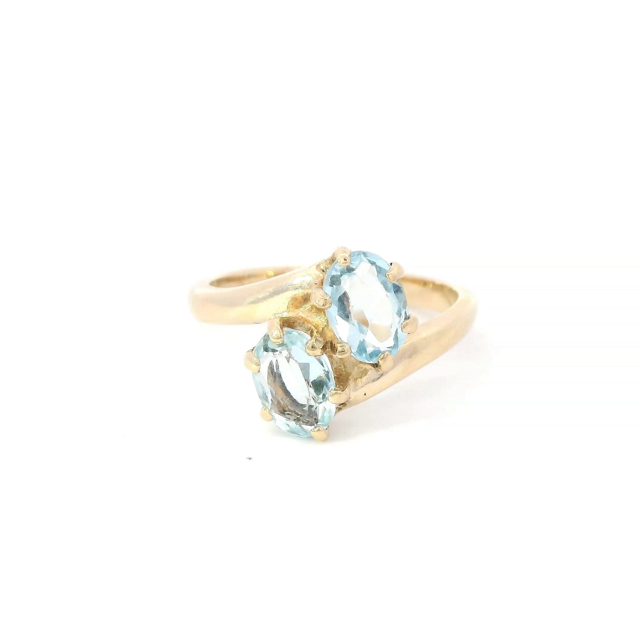 Estate Collection: 14K Yellow Gold 2-Stone Oval Aquamarine Bypass Ring