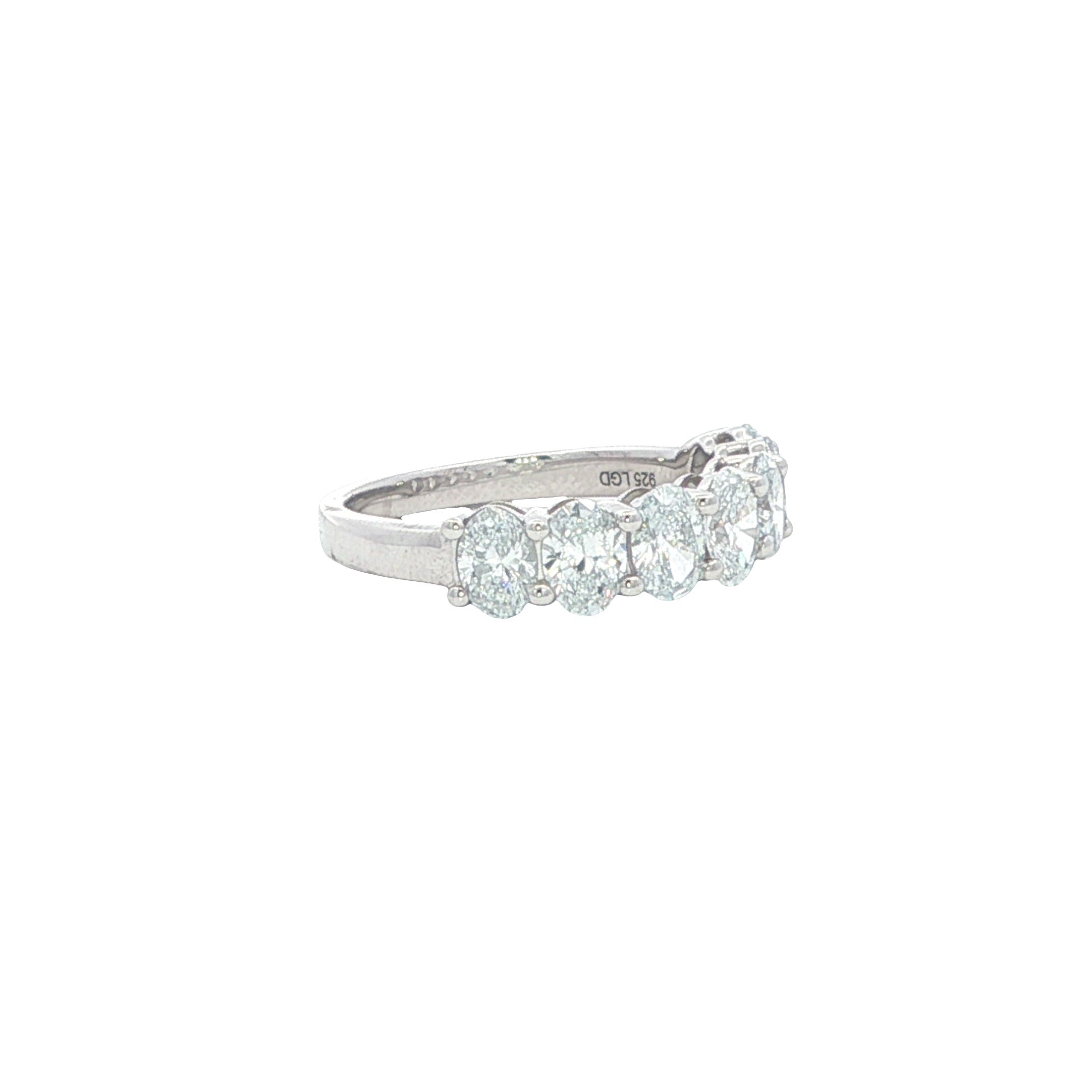 Diamond ring with three clear stones on a white background