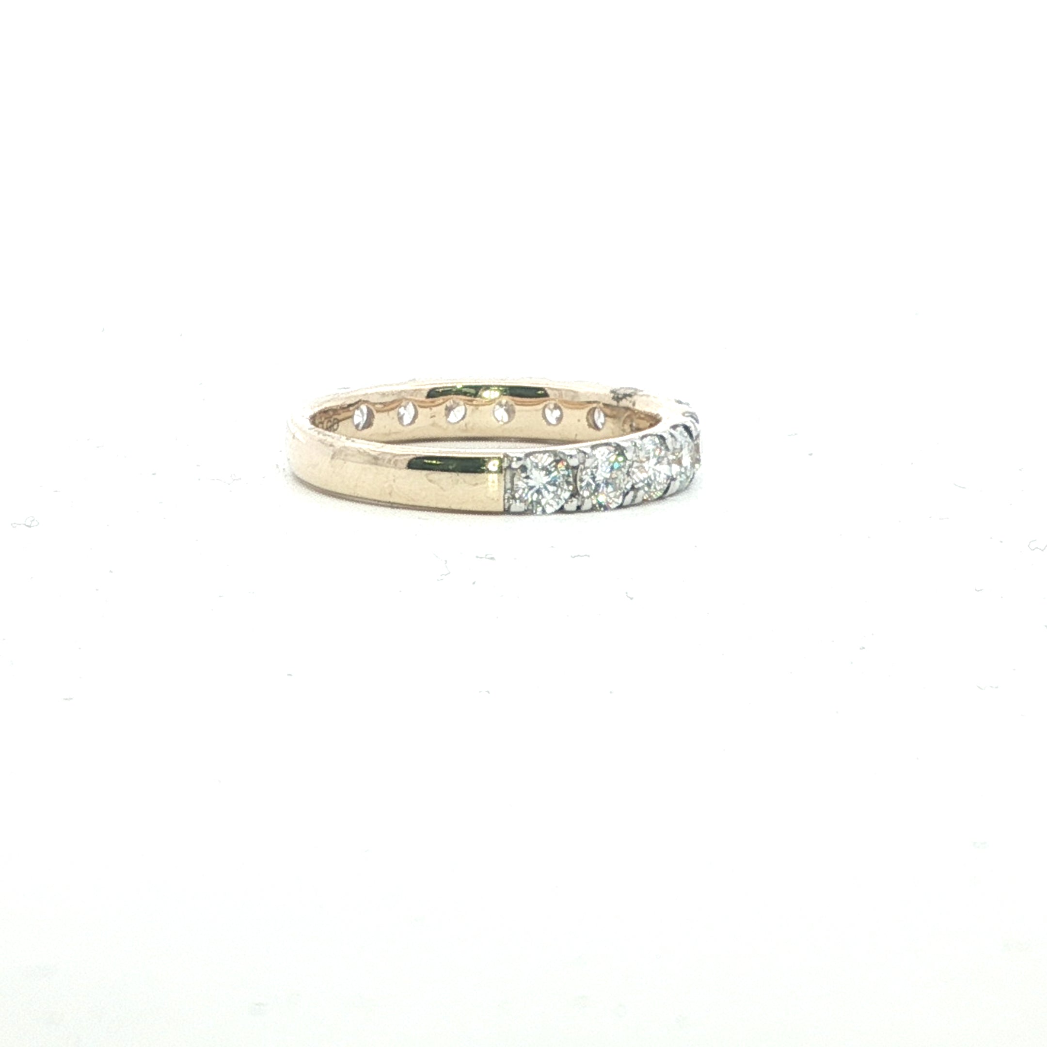Gold ring with embedded diamonds on a white background