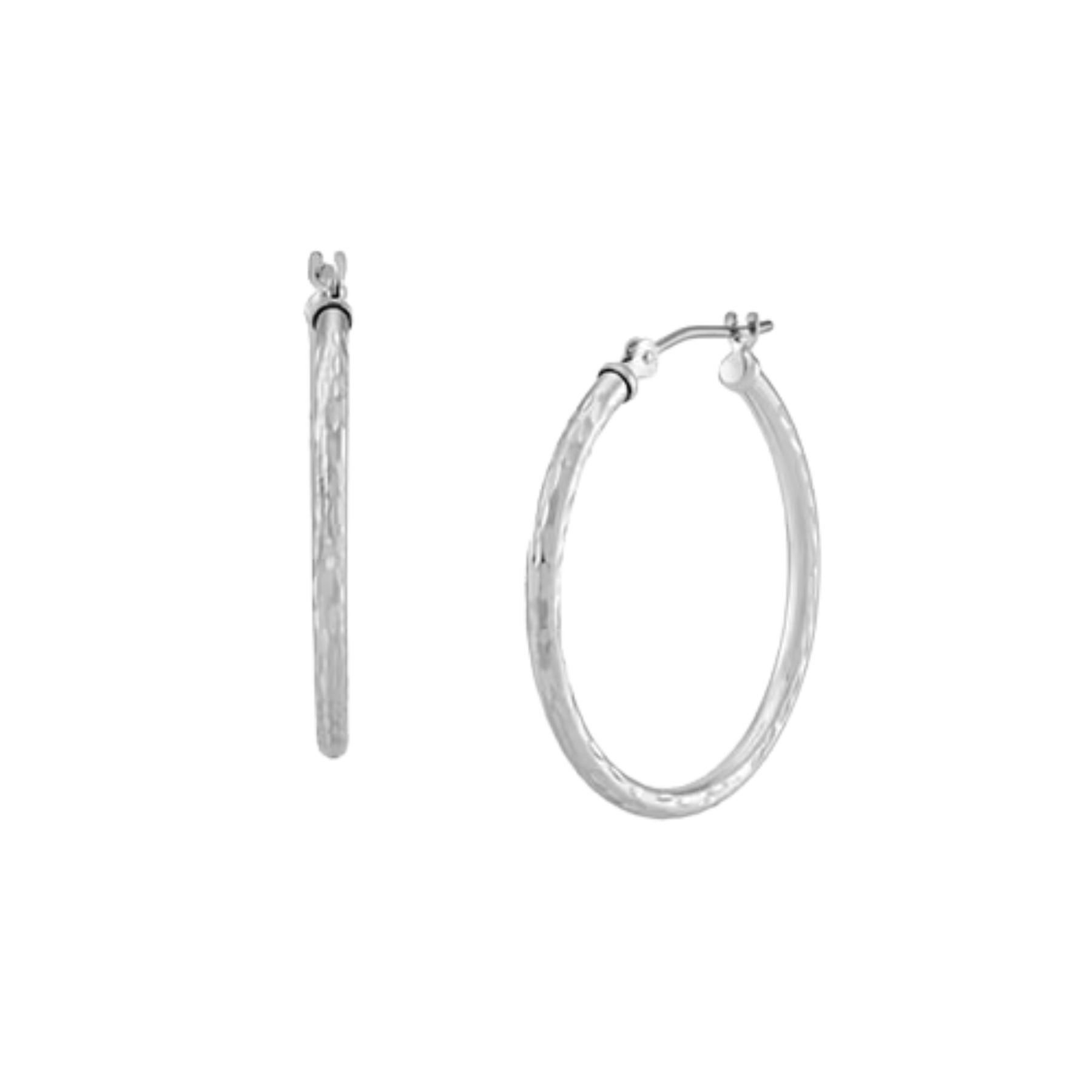A pair of textured silver hoop earrings shown on a plain white background, with one earring standing vertically and the other in a horizontal orientation.