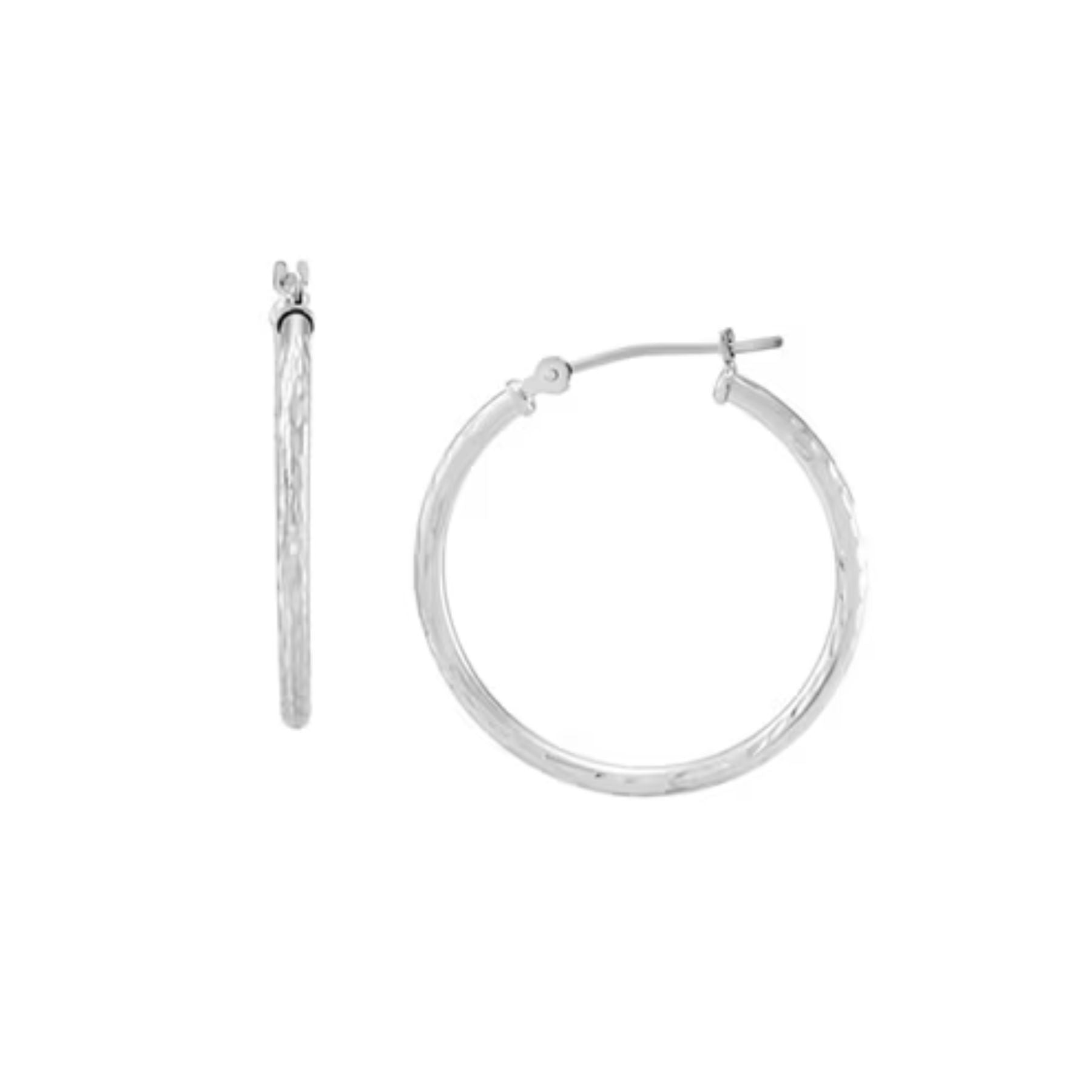 A pair of textured silver hoop earrings shown on a plain white background, with one earring displayed front-facing and the other shown in side profile.