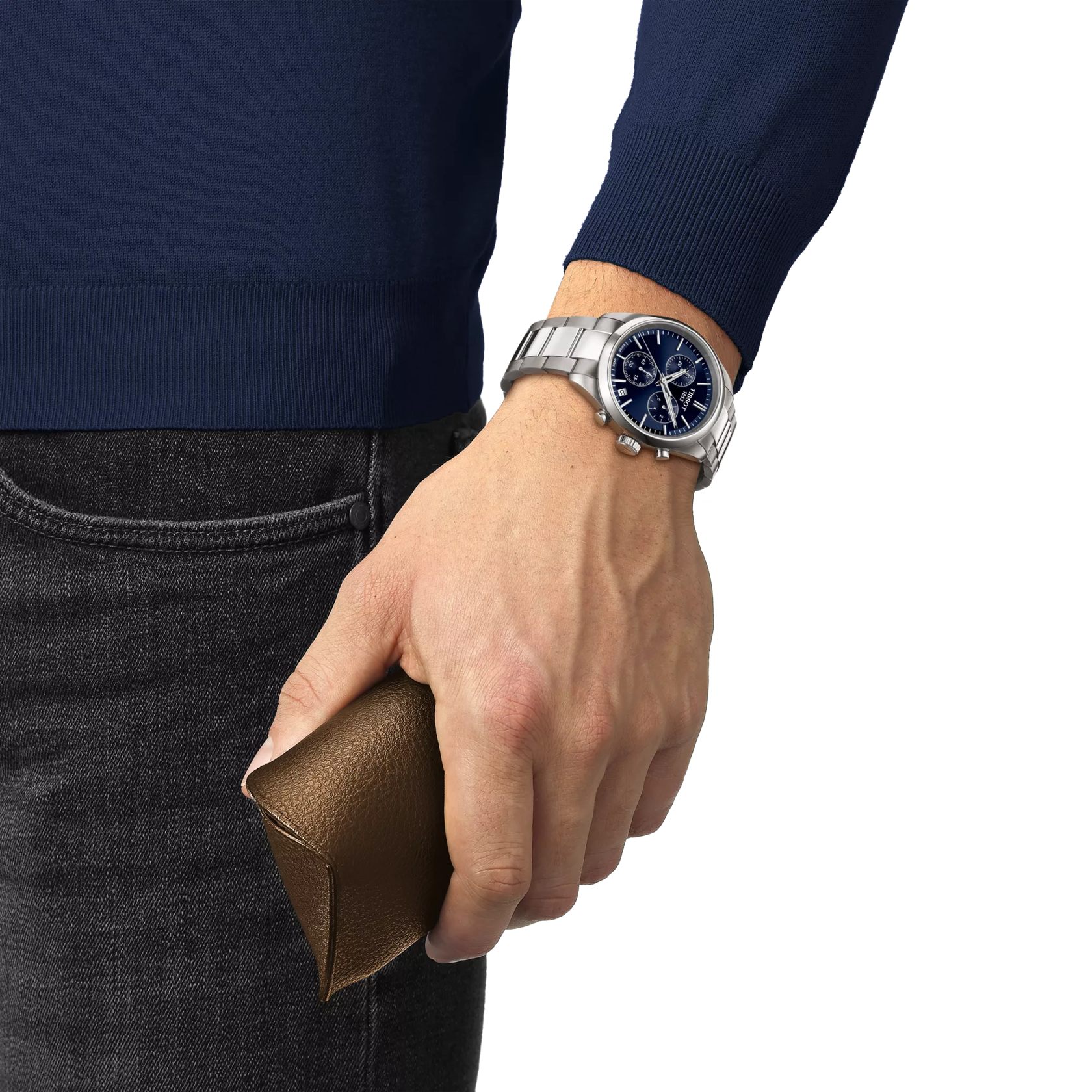 Hand wearing a silver watch with a blue face, holding a brown leather wallet, against a white background.