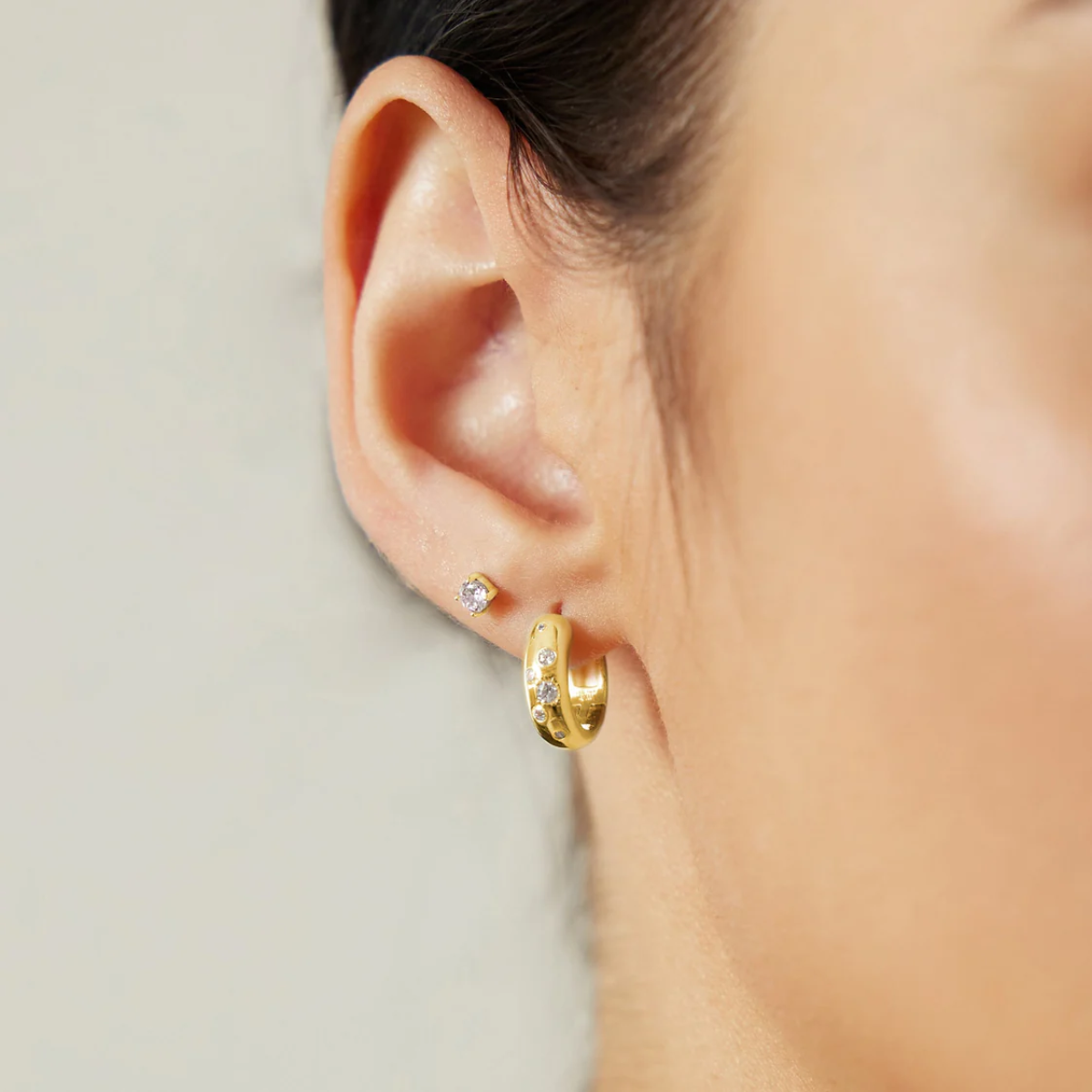 Ania Haie Gold Small Chubby Sparkling Huggie Hoop Earrings on a model