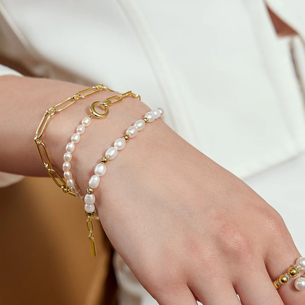 Pearl beaded bracelet on white background by ania haie