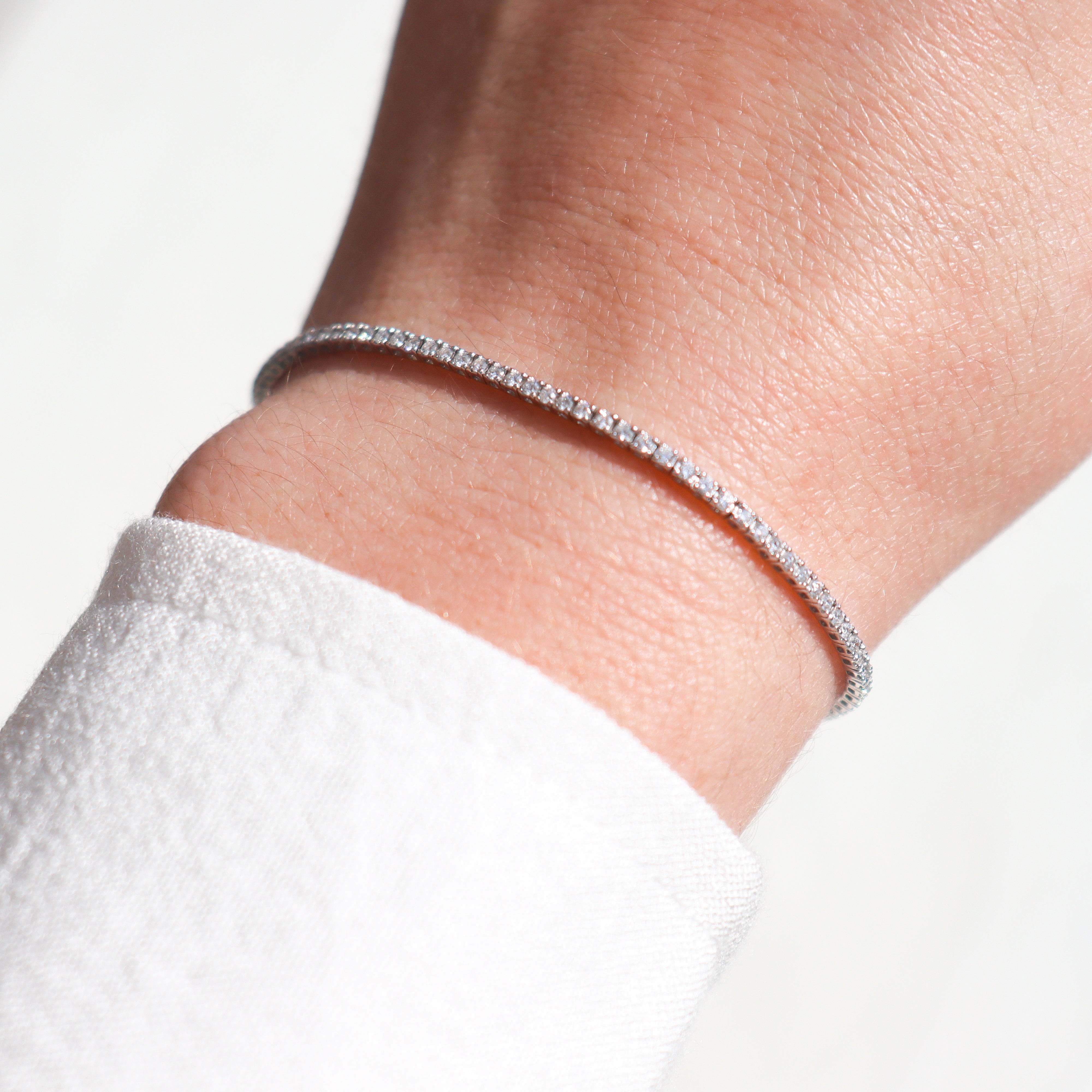 14K White Gold 1CTW. Lab-Grown Diamond Tennis Bracelet on a model's wrist.