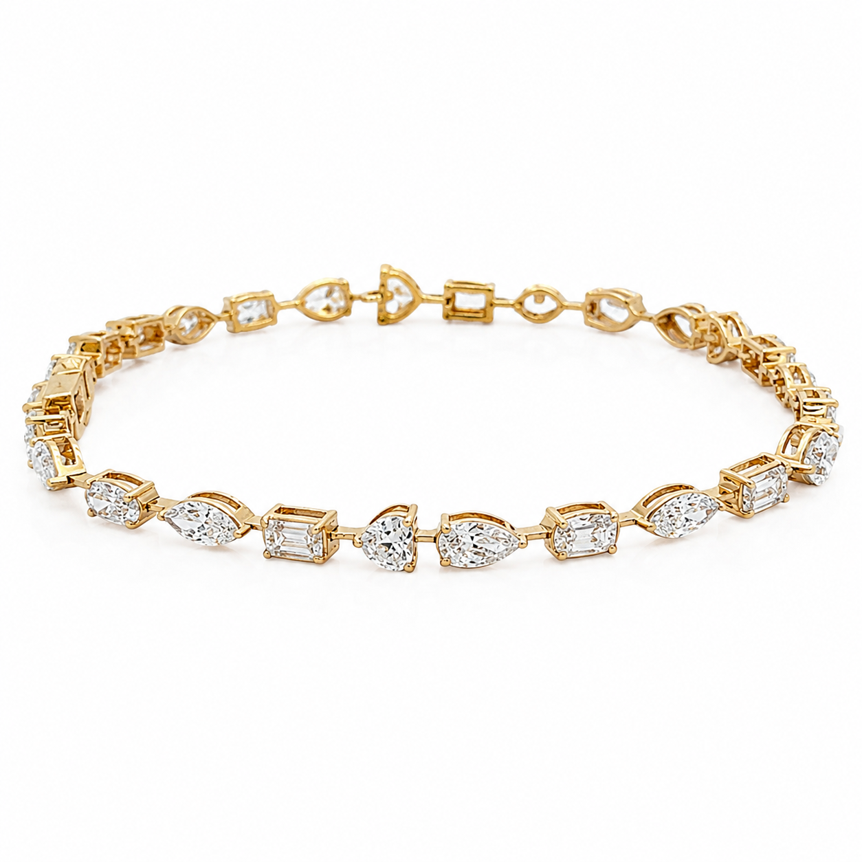 Gold tennis bracelet on a white background