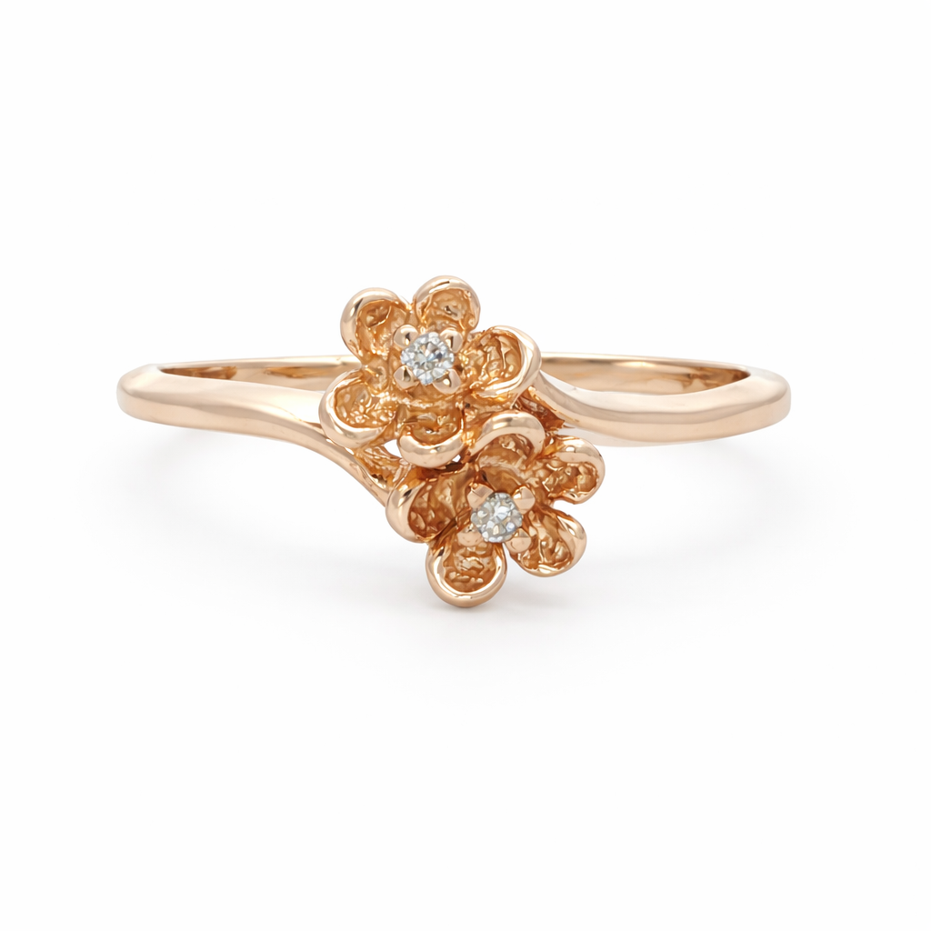 Rose gold floral ring with diamonds on a white background