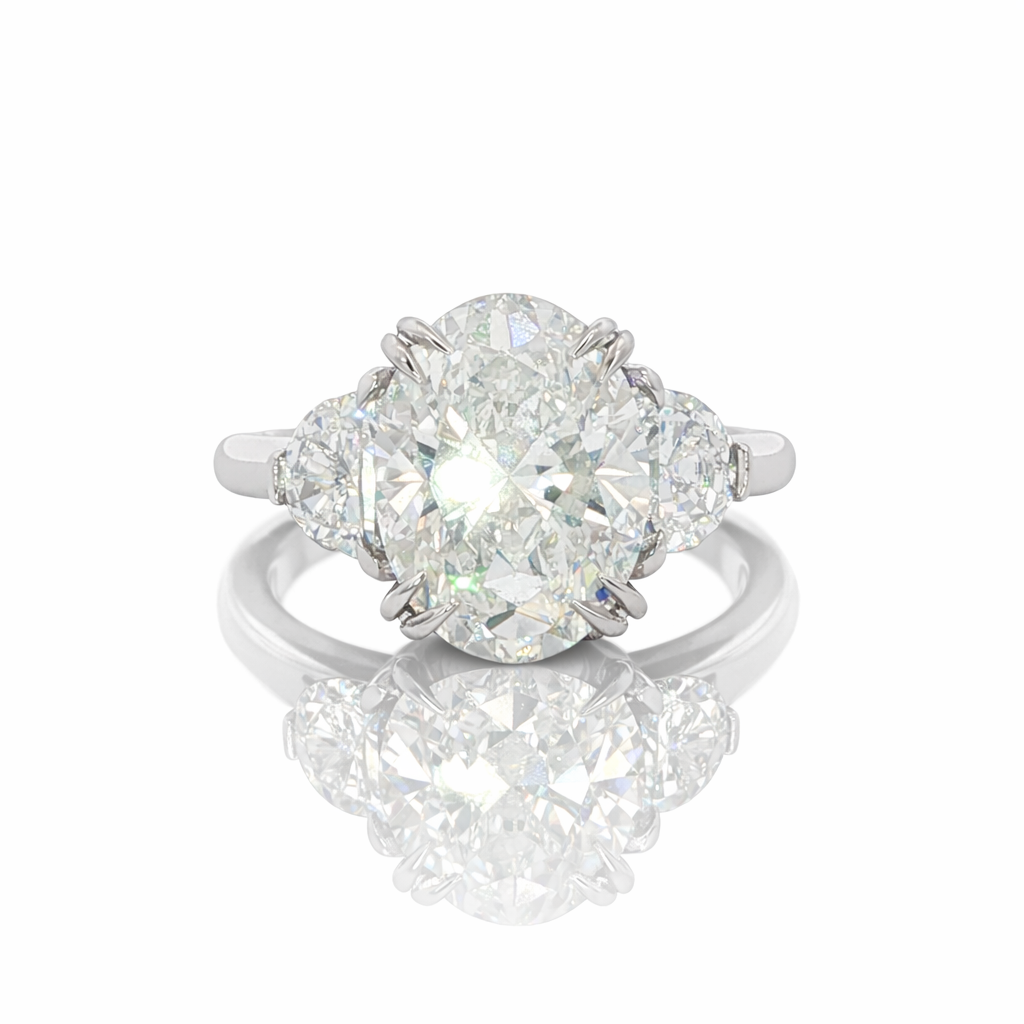 Diamond ring with two pear-shaped diamonds on a white background