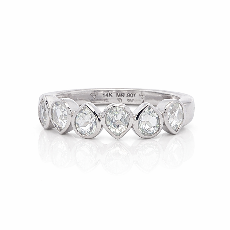 Silver ring with pear-shaped diamonds on a white background