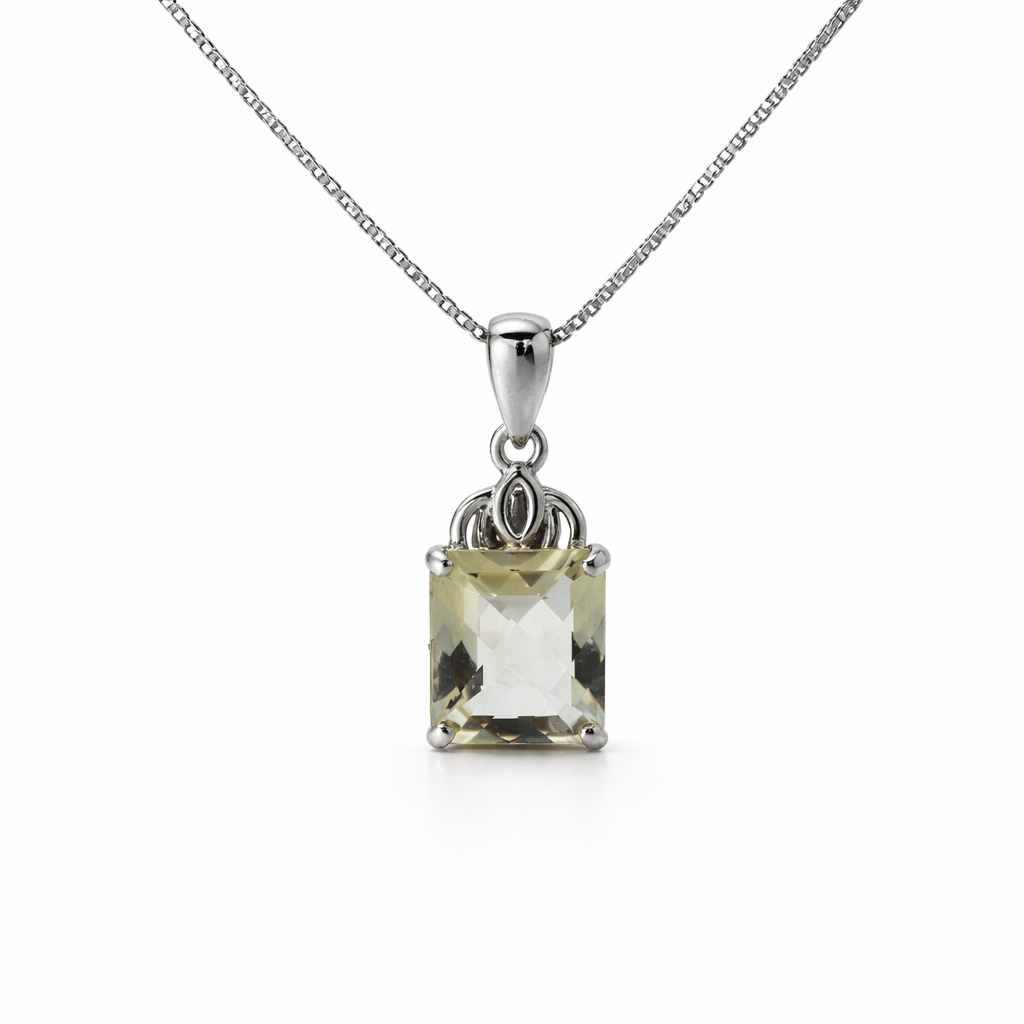 Silver pendant with a green gemstone on a white background