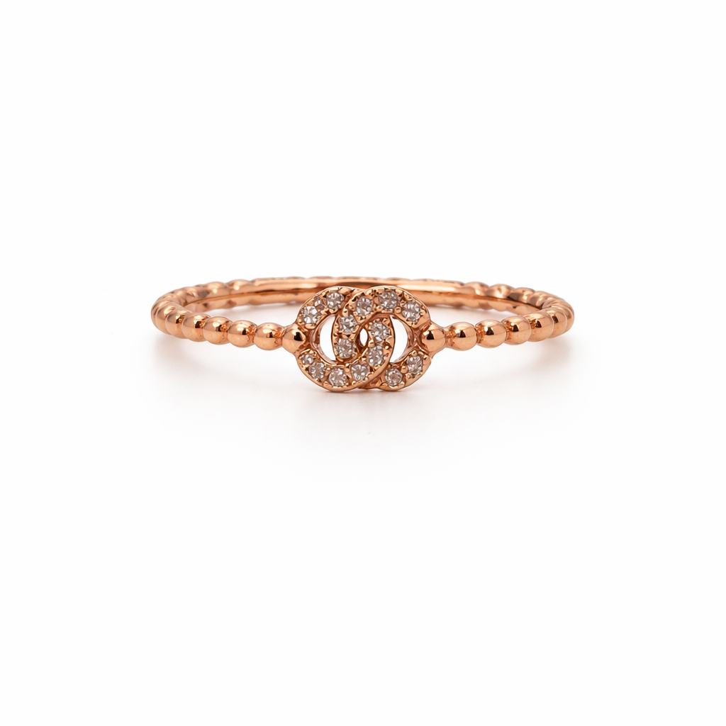 Rose gold ring with a small diamond design on a white background