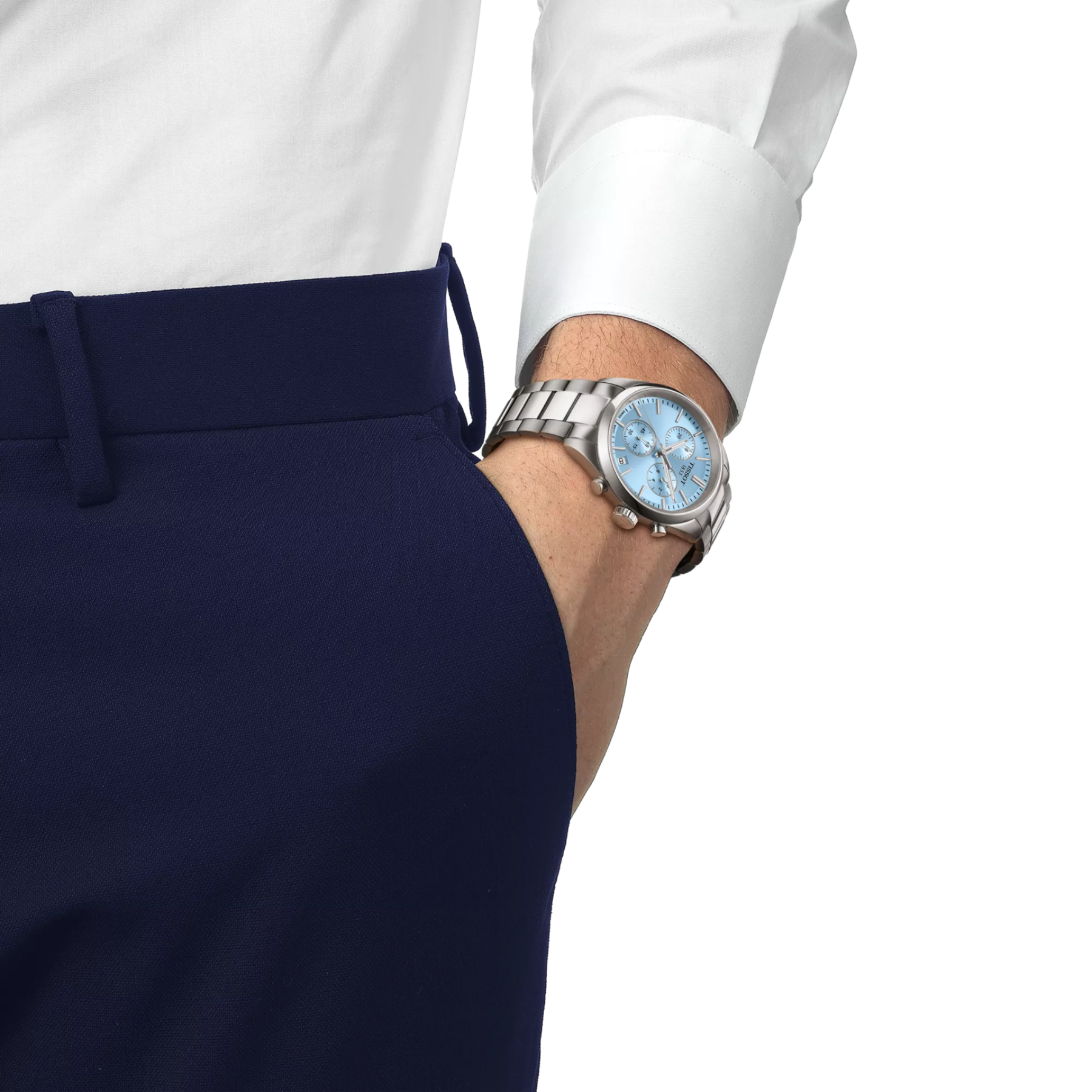 Silver watch on a wrist with a white shirt and navy pants against a white background