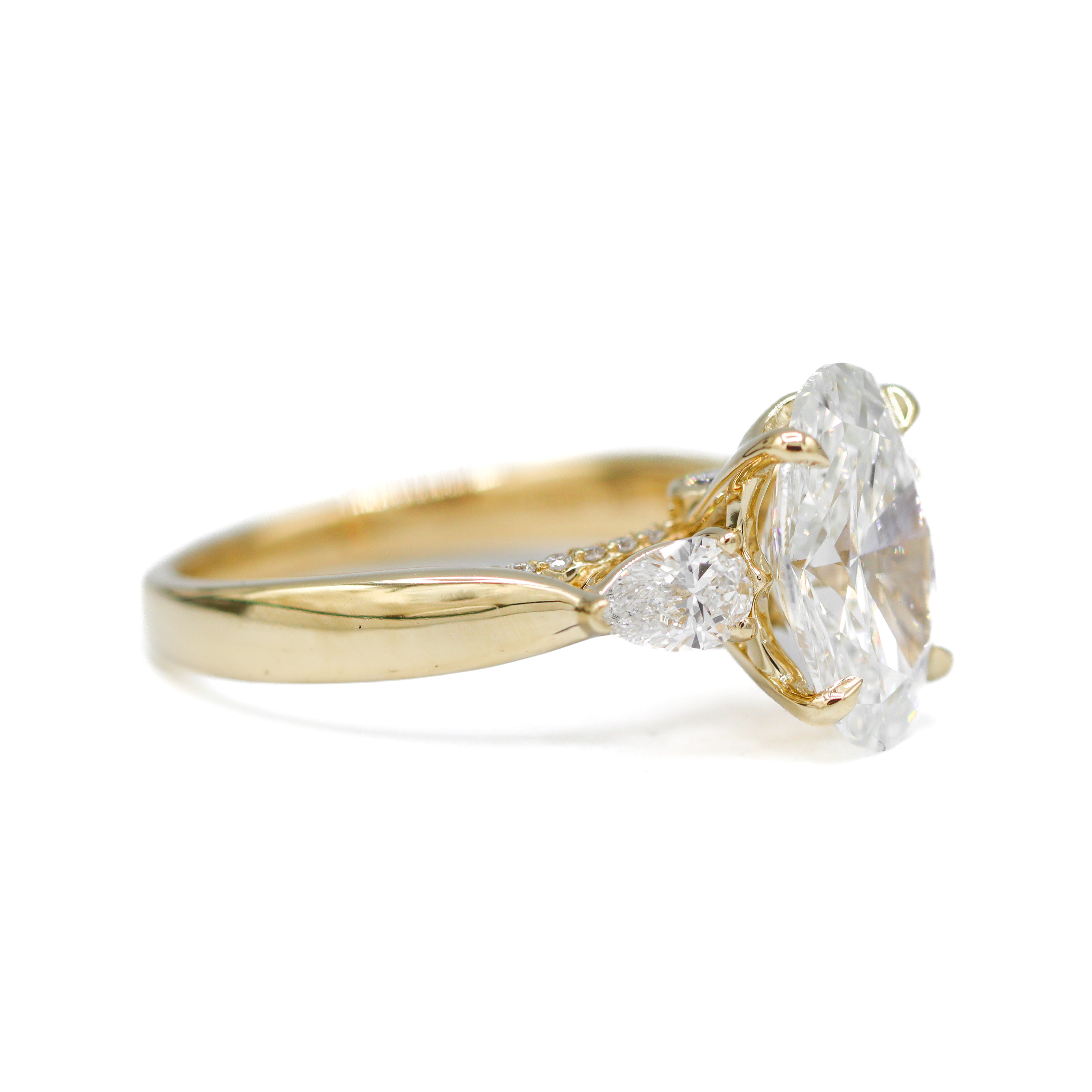 Left side view of 14K Yellow Gold 3-2/3CTW. Certified Oval-Cut Lab-Grown Diamond 3-Stone Accented Engagement Ring