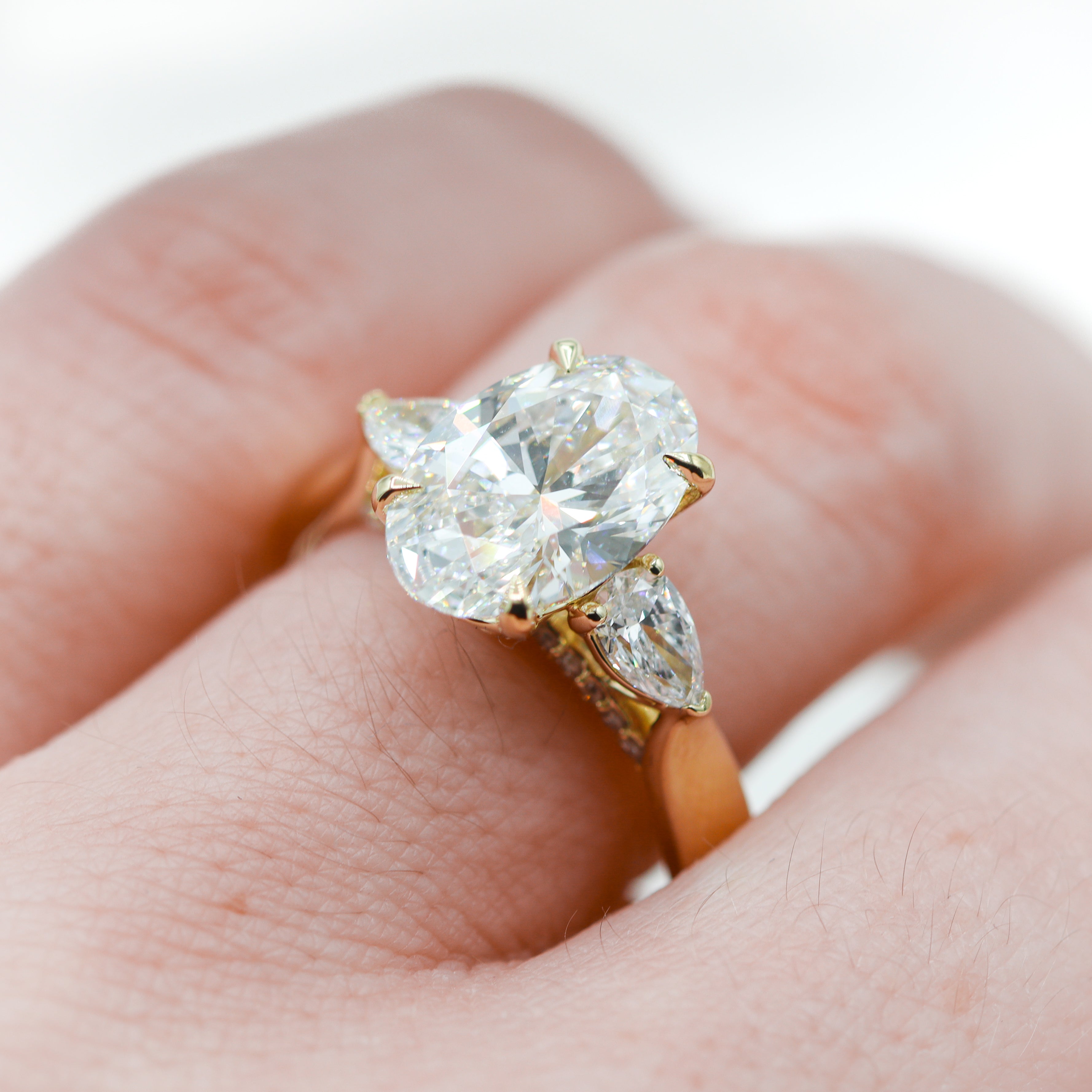 14K Yellow Gold 3-2/3CTW. Certified Oval-Cut Lab-Grown Diamond 3-Stone Accented Engagement Ring on a hand