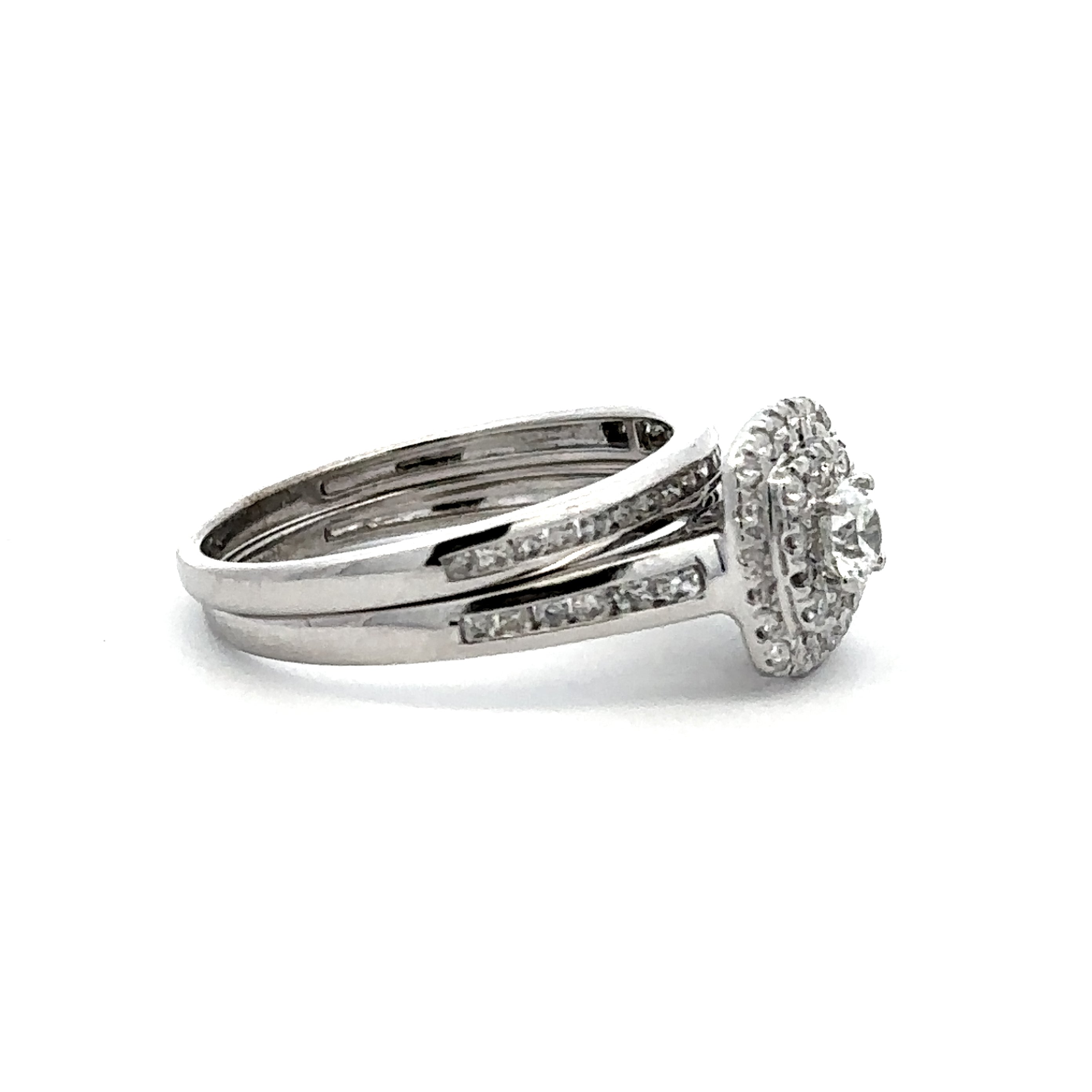 A silver-toned double-band ring featuring a round-cut center stone surrounded by a small halo and channel-set stones, shown on a plain white background.