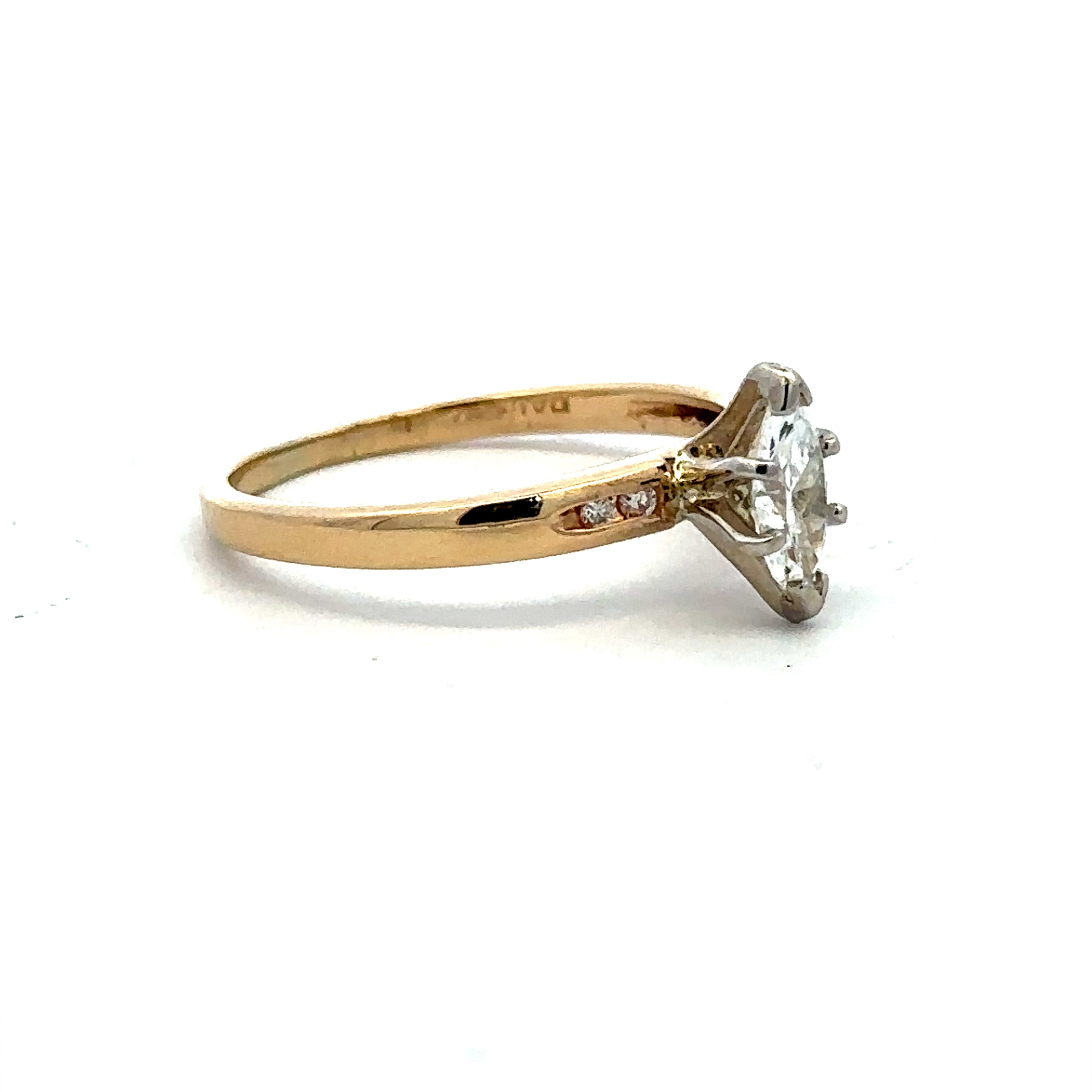A yellow gold ring with a large clear round-cut gemstone in a prong setting, accented by small diamonds on the band, shown on a plain white background.