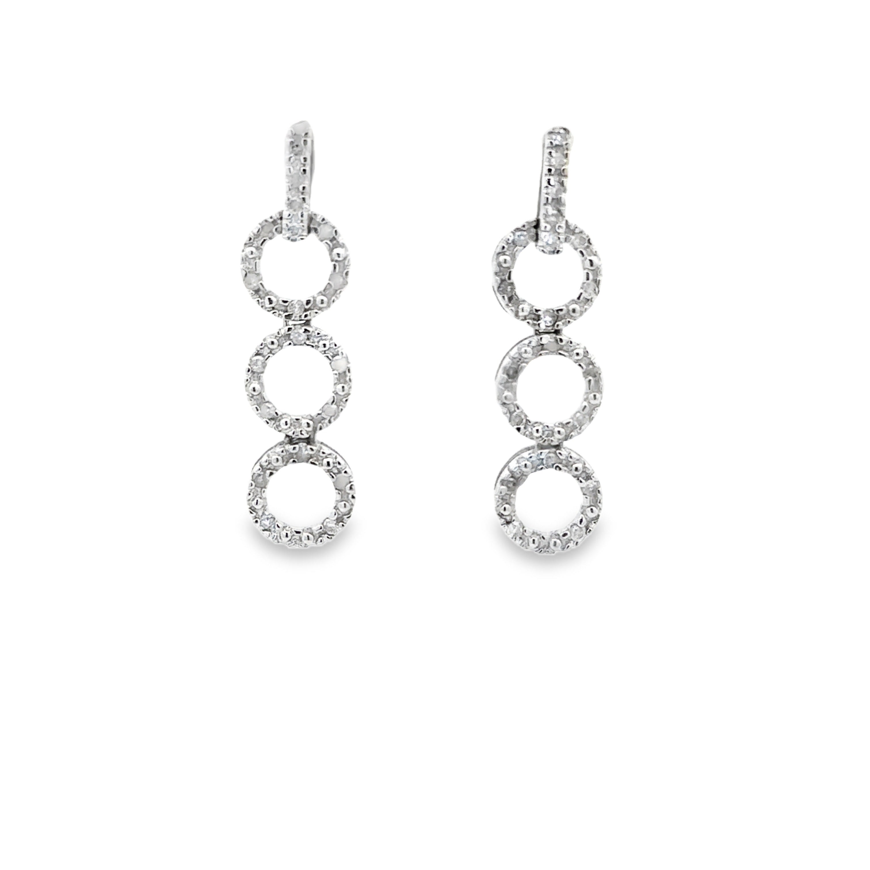 A pair of silver drop earrings featuring three stacked, bezel-set circular links on each drop, shown against a plain white background.