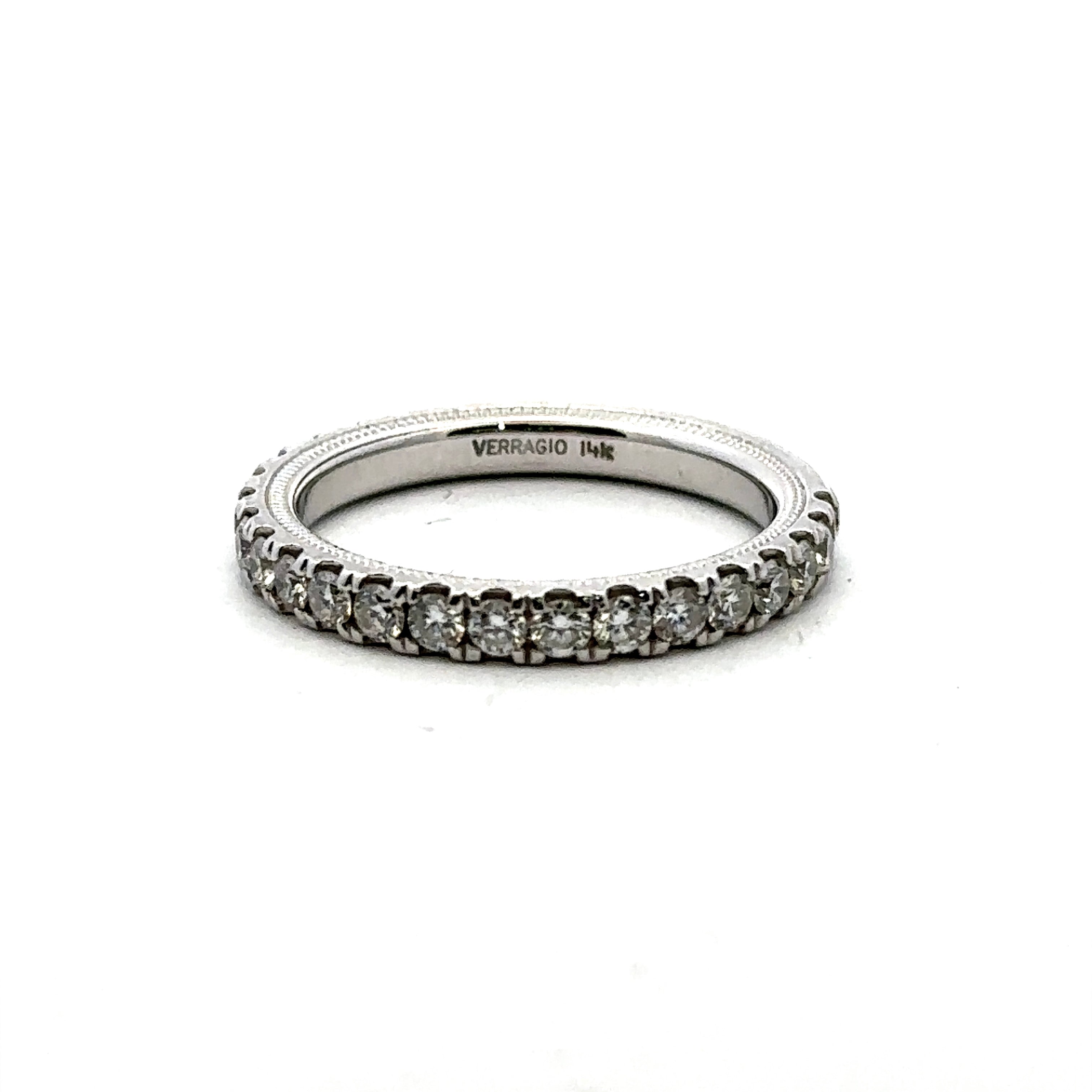 A silver-tone eternity ring with a row of small round-cut clear stones, featuring 'VERRAGIO INK' engraved on the inner band, set against a plain white background.