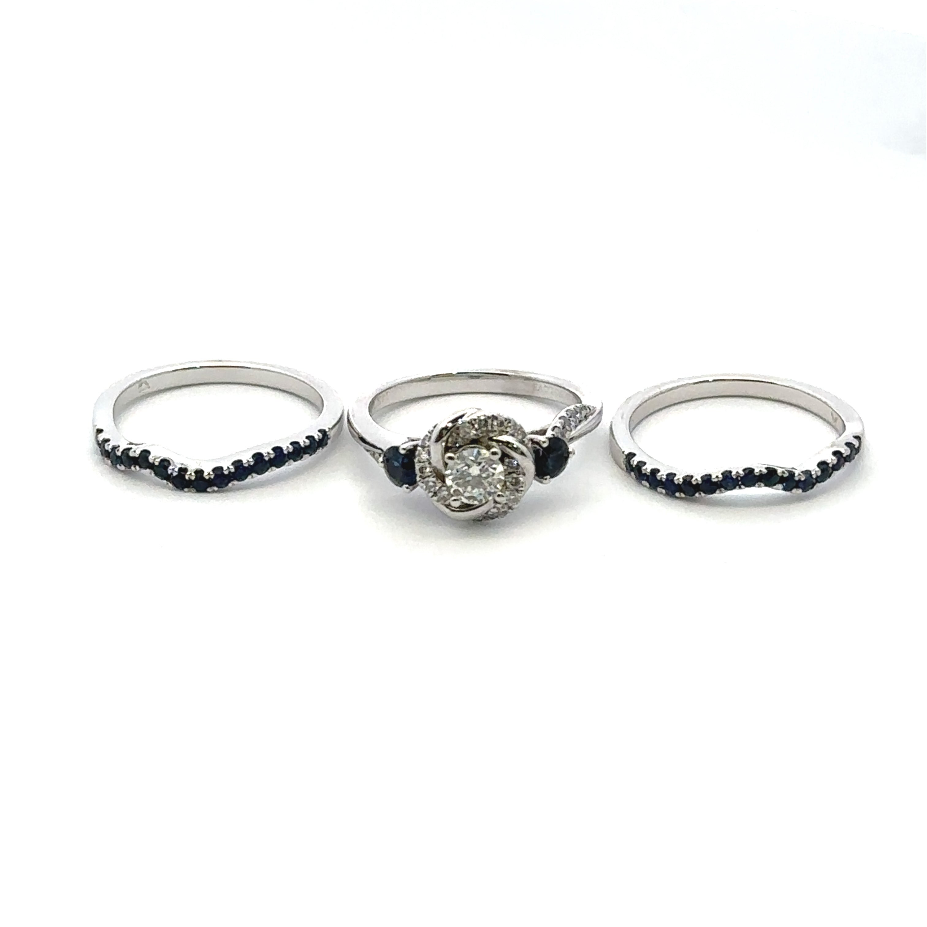 Sapphire and diamond ring set on a white background
