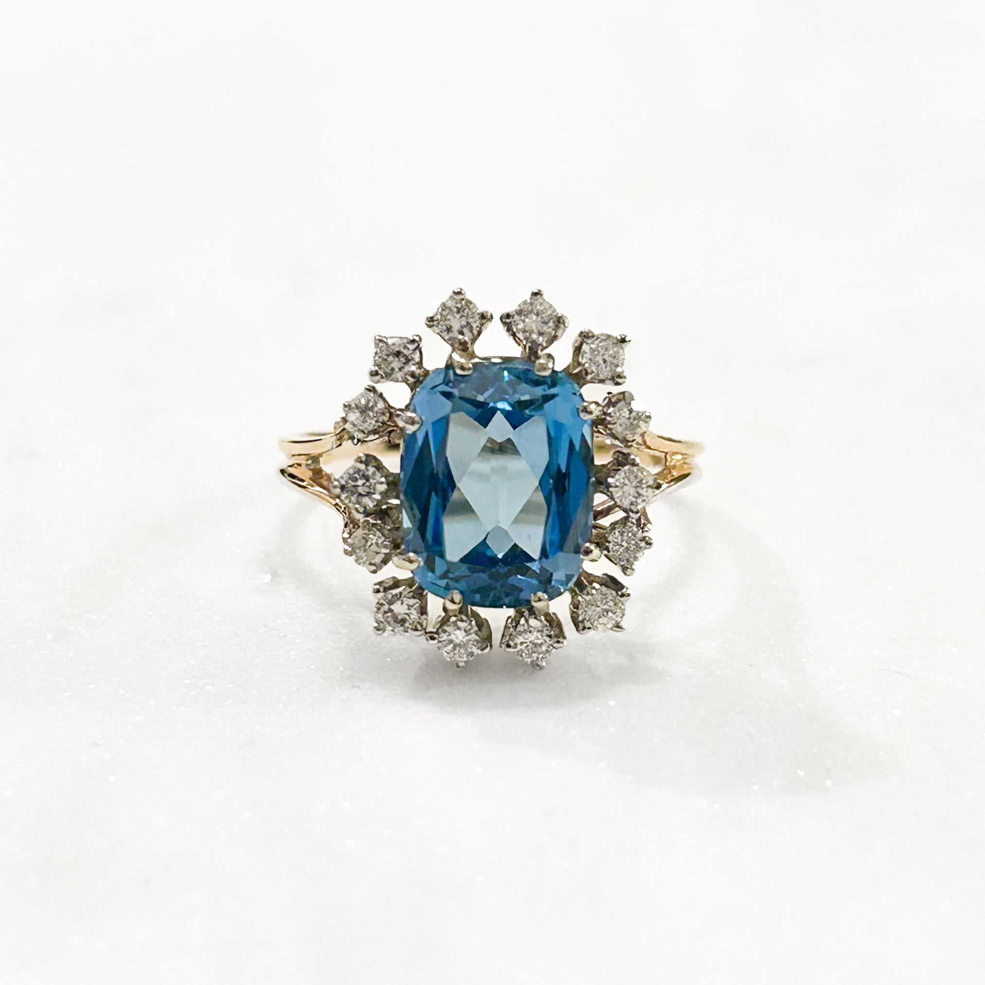 Estate Collection: 14K Yellow Gold Elongated Cushion Blue Topaz and Diamond Halo Cocktail Ring