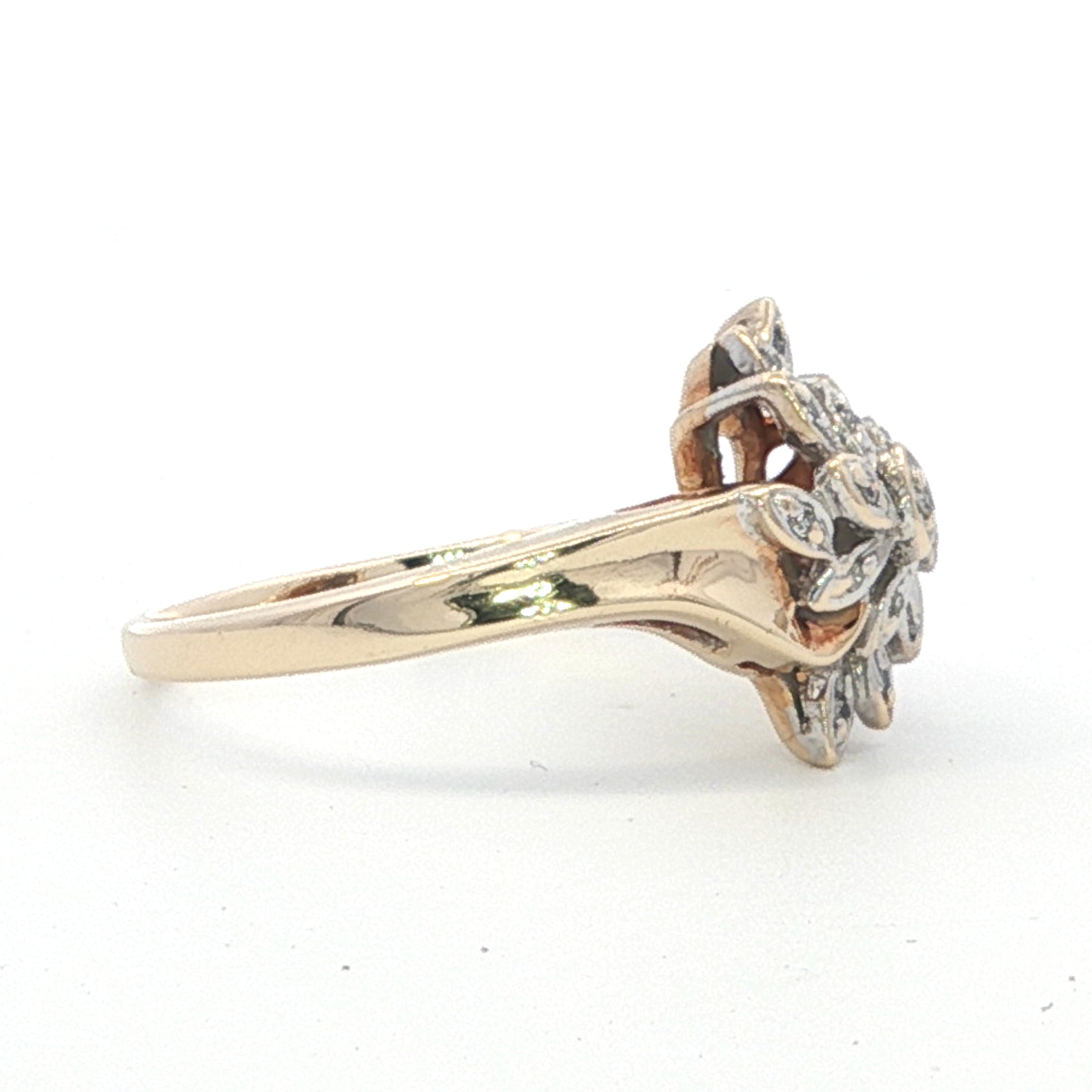 Gold ring with diamond design on a white background