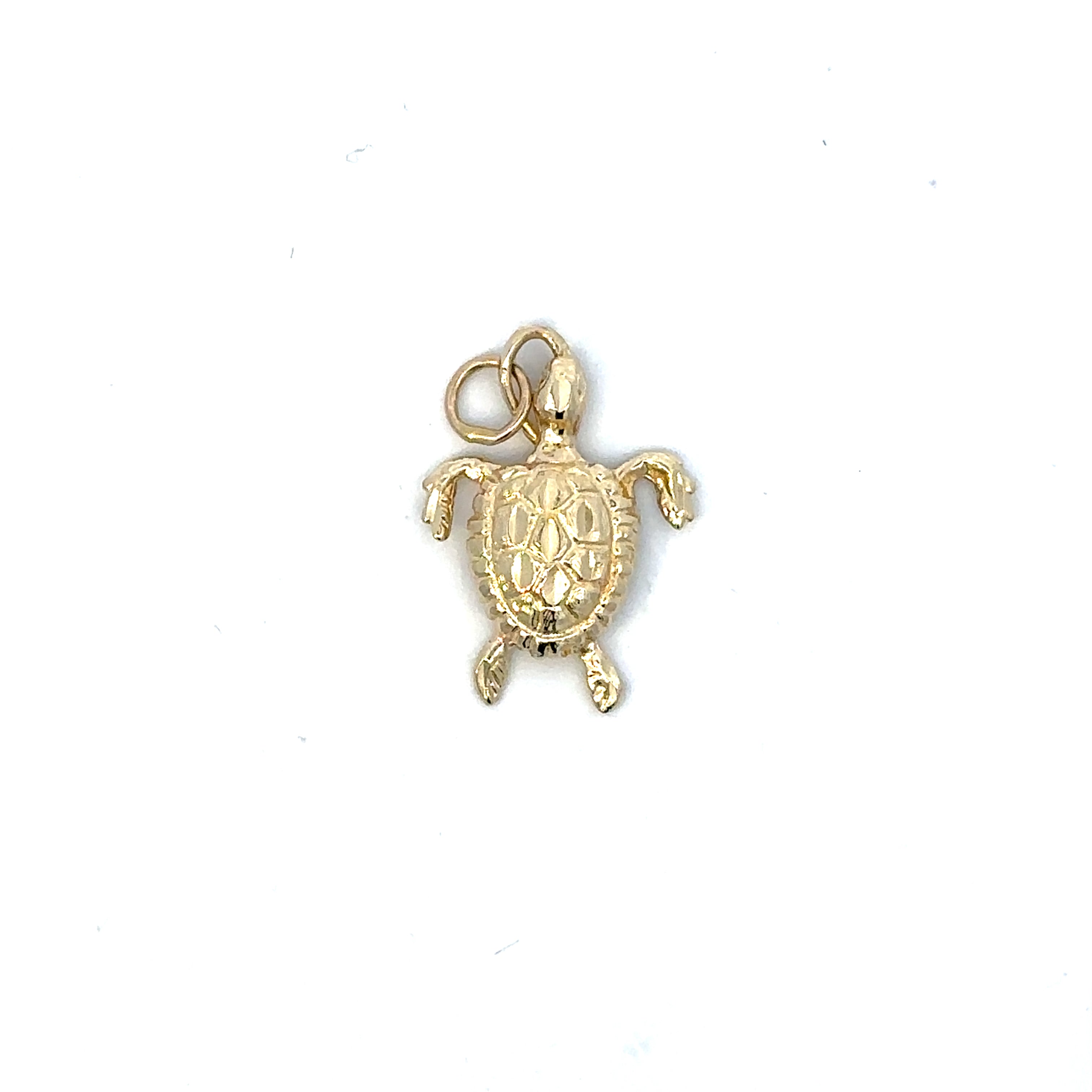Gold turtle charm on a white background