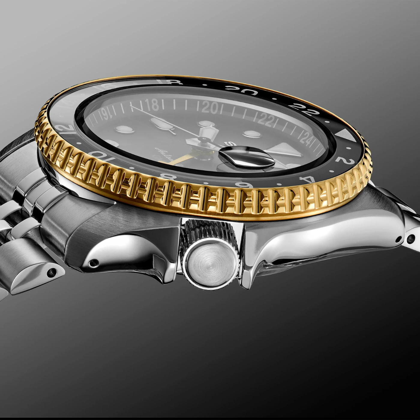 Luxury watch with gold and silver design on a gray background