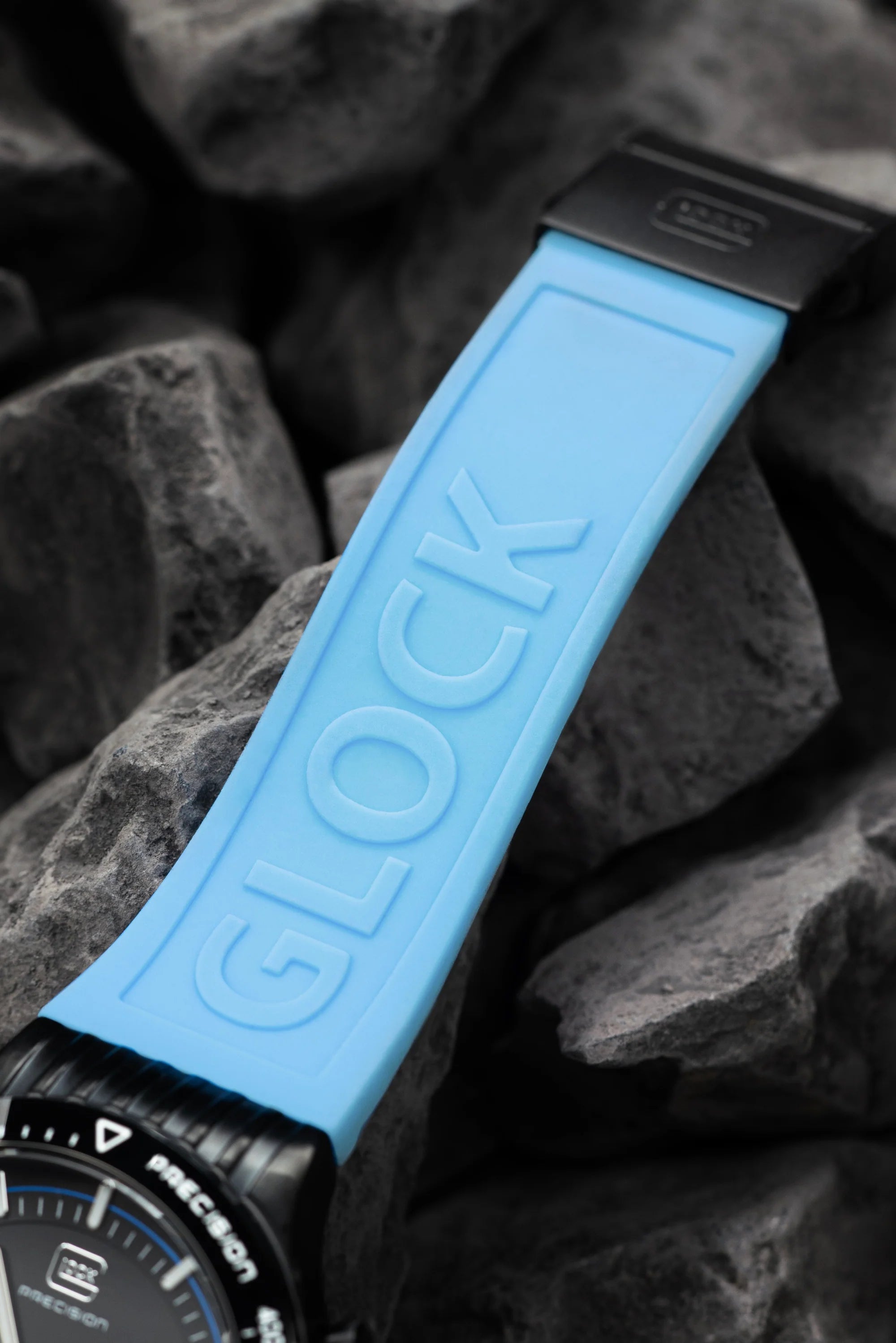 Close up of the strap on this Black Stainless Steel With Blue Silicone Strap Glock Watch on white background.