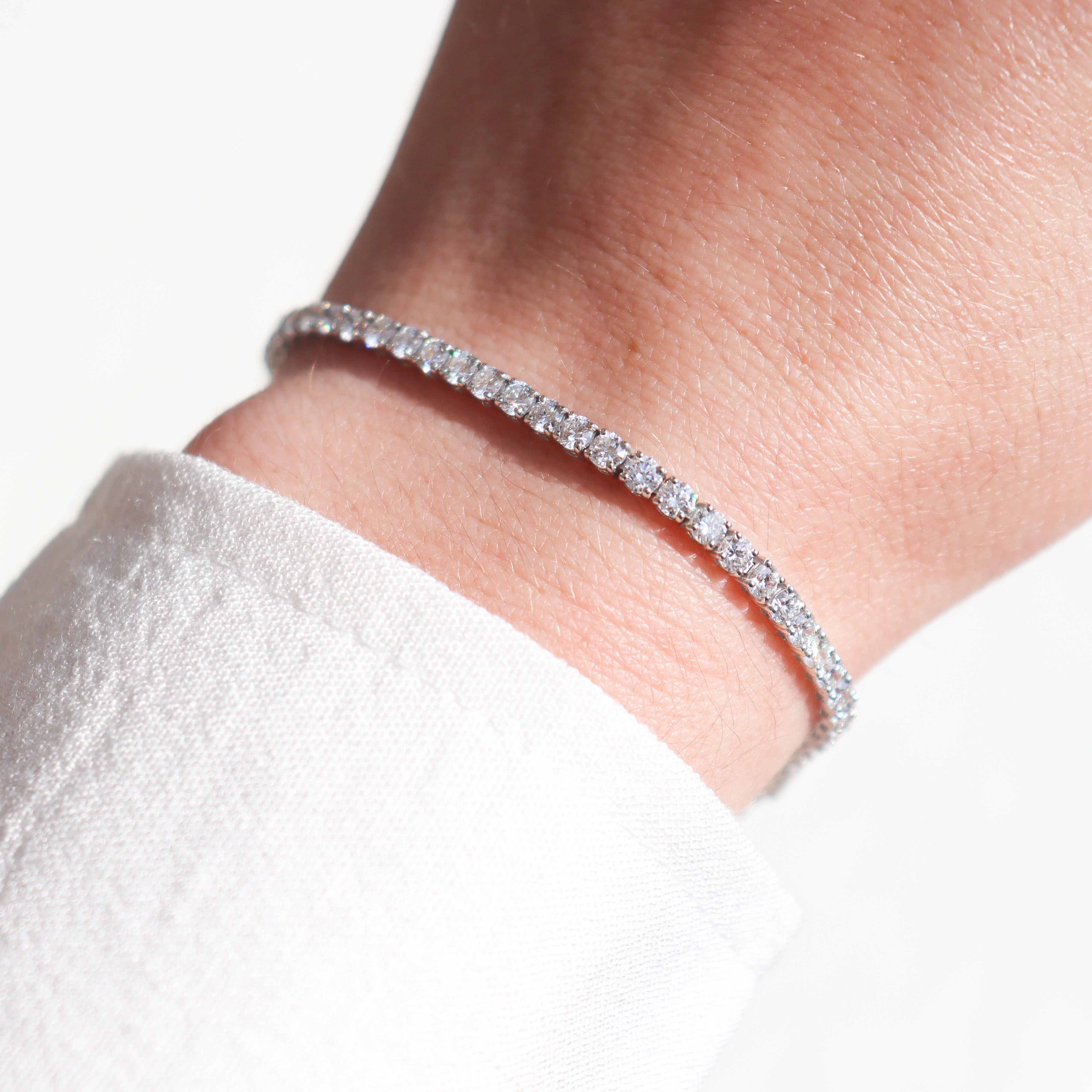 10K White Gold 5CT. Lab-Grown Diamond Tennis Bracelet on a model's wrist.
