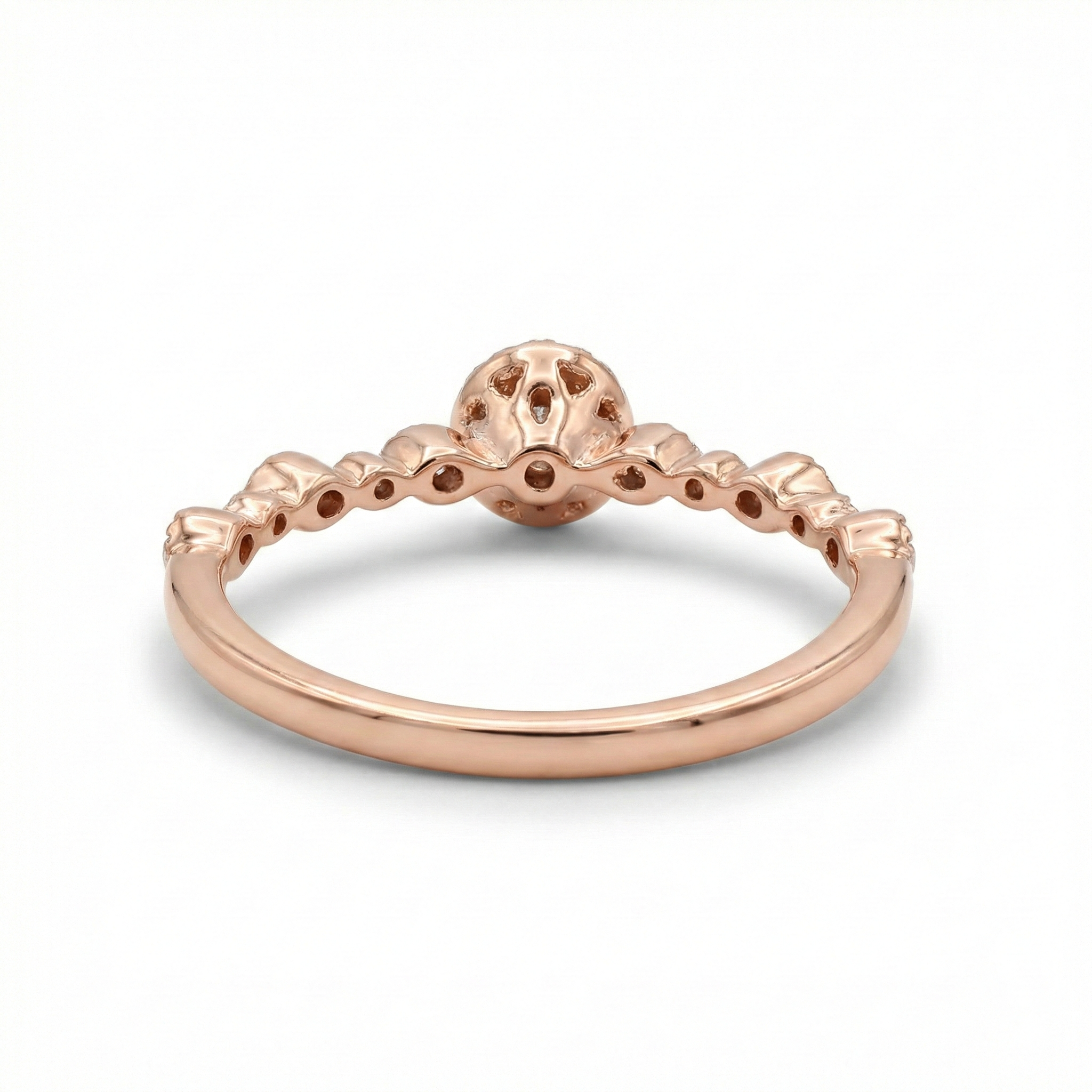 Rose gold ring with a unique design on a white background