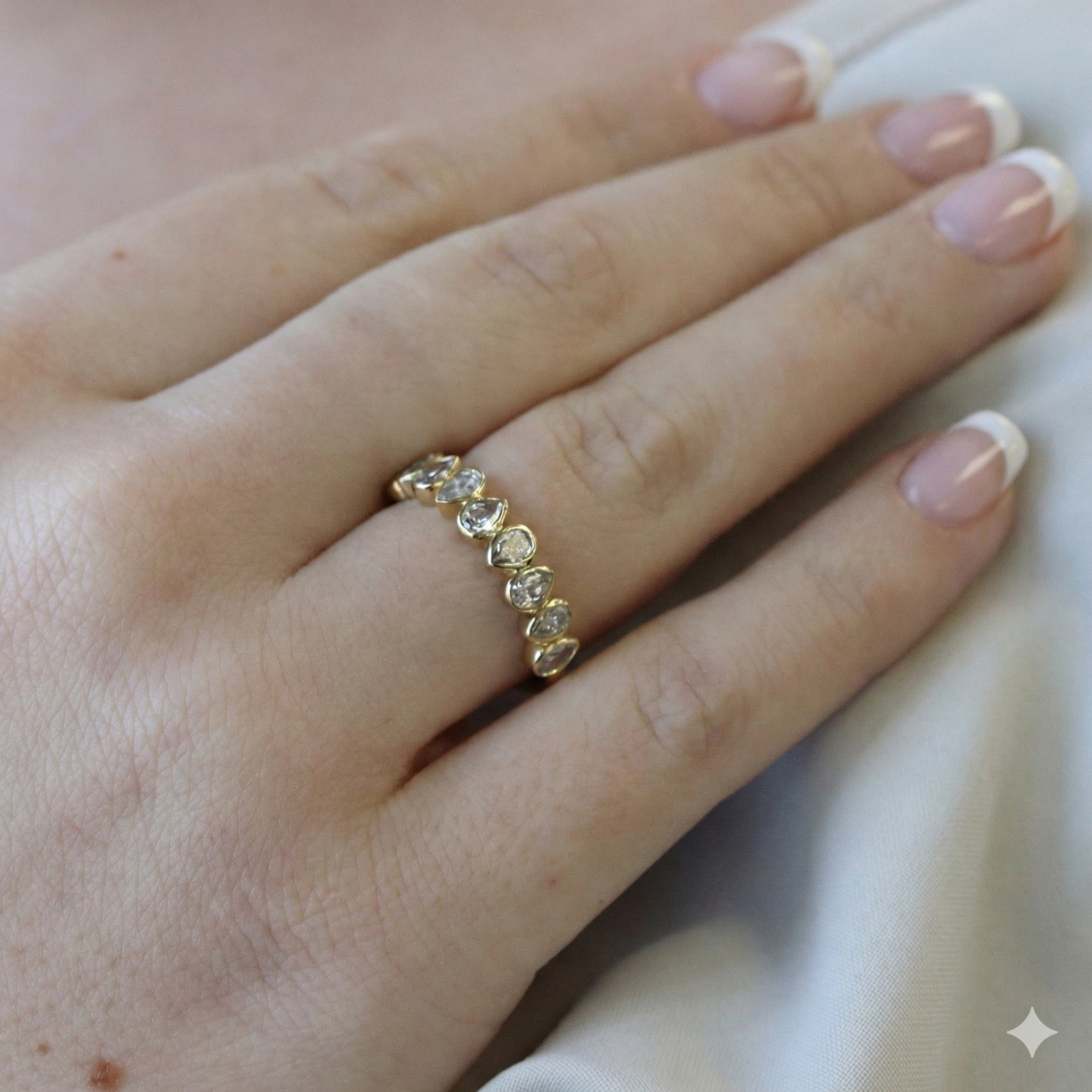 Gold ring with diamonds on a person's finger