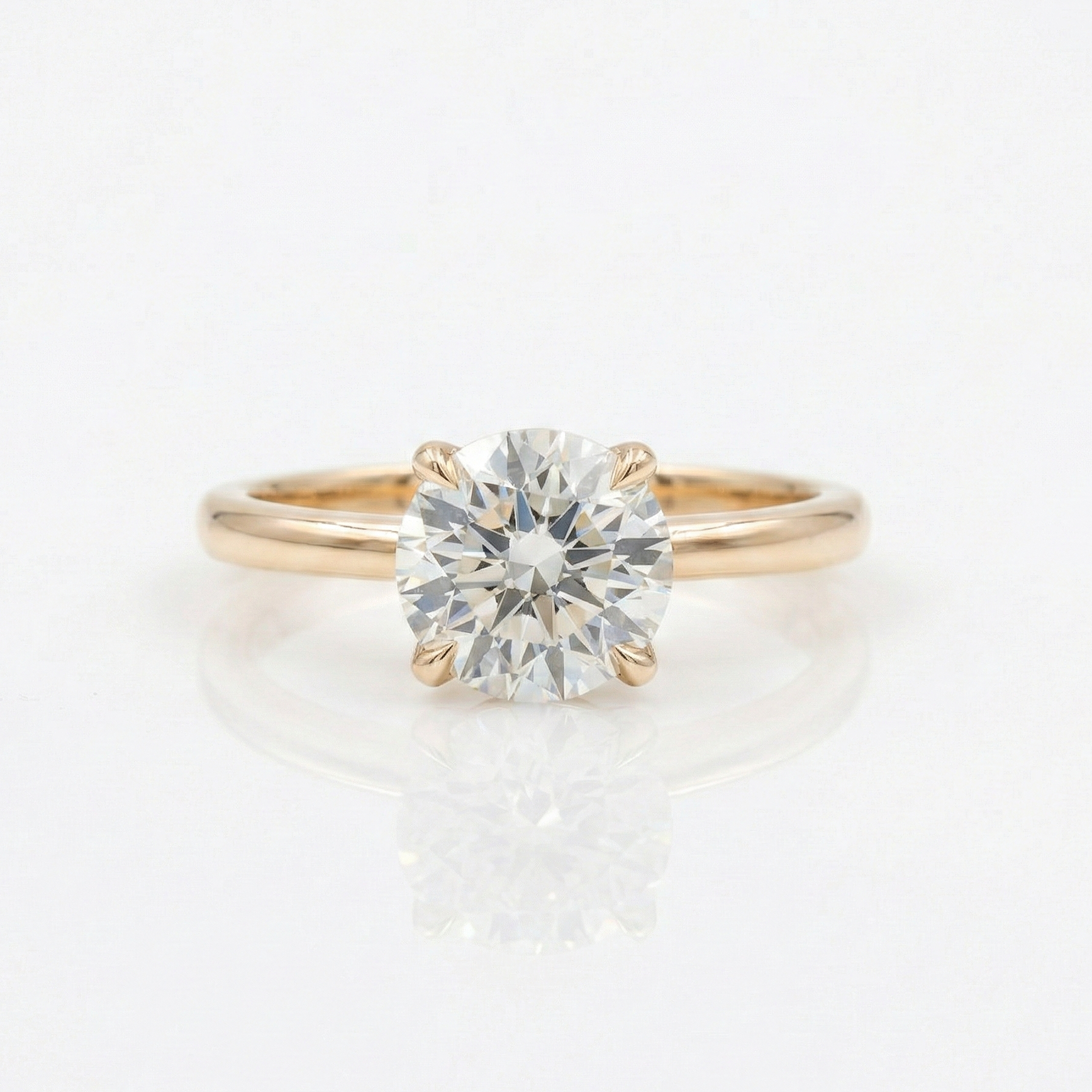 Gold ring with a diamond on a white background