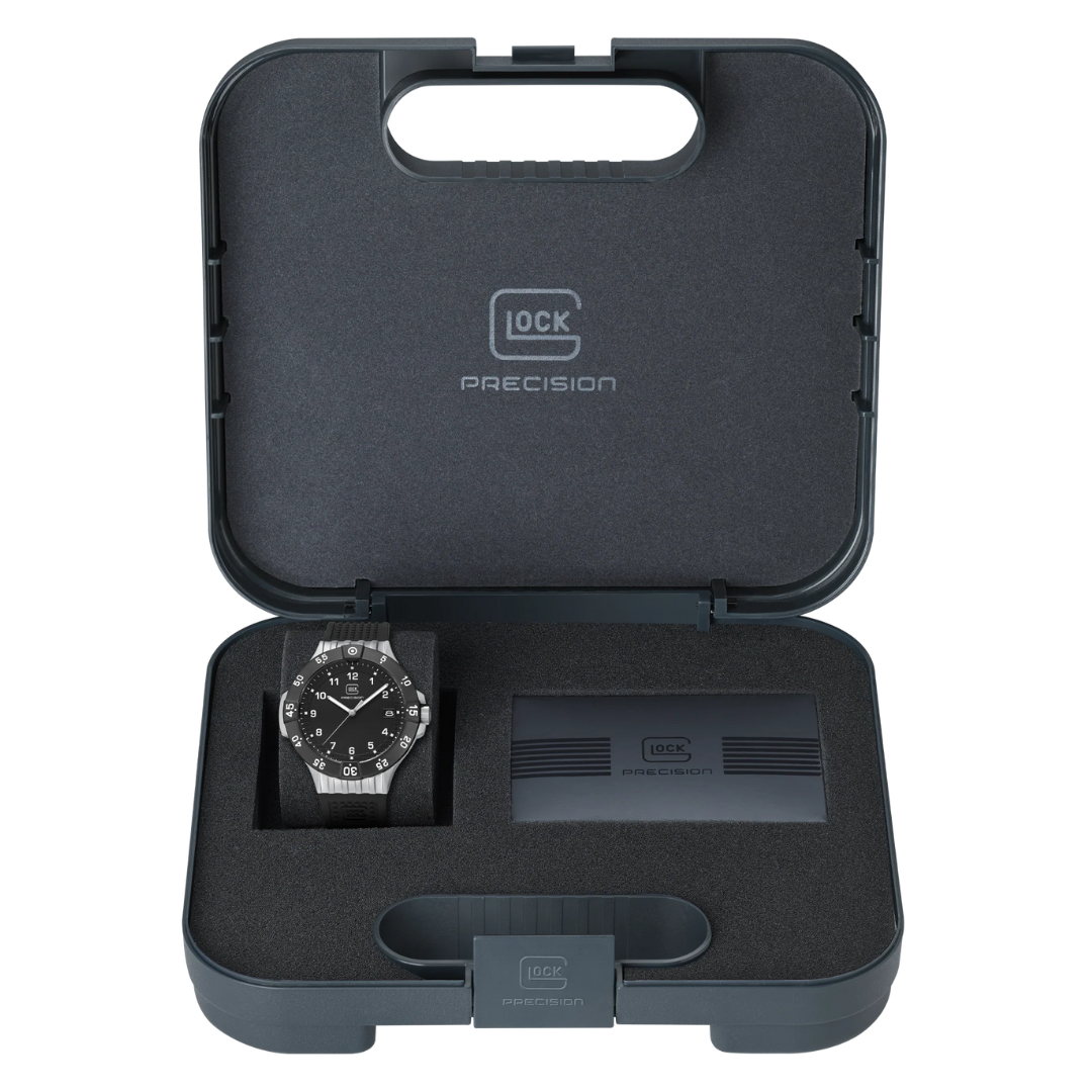 Picture of GLOCK Sandblasted Silver-Tone Stainless Steel With Black Silicone Band Watch in its case, on a tranparent background.