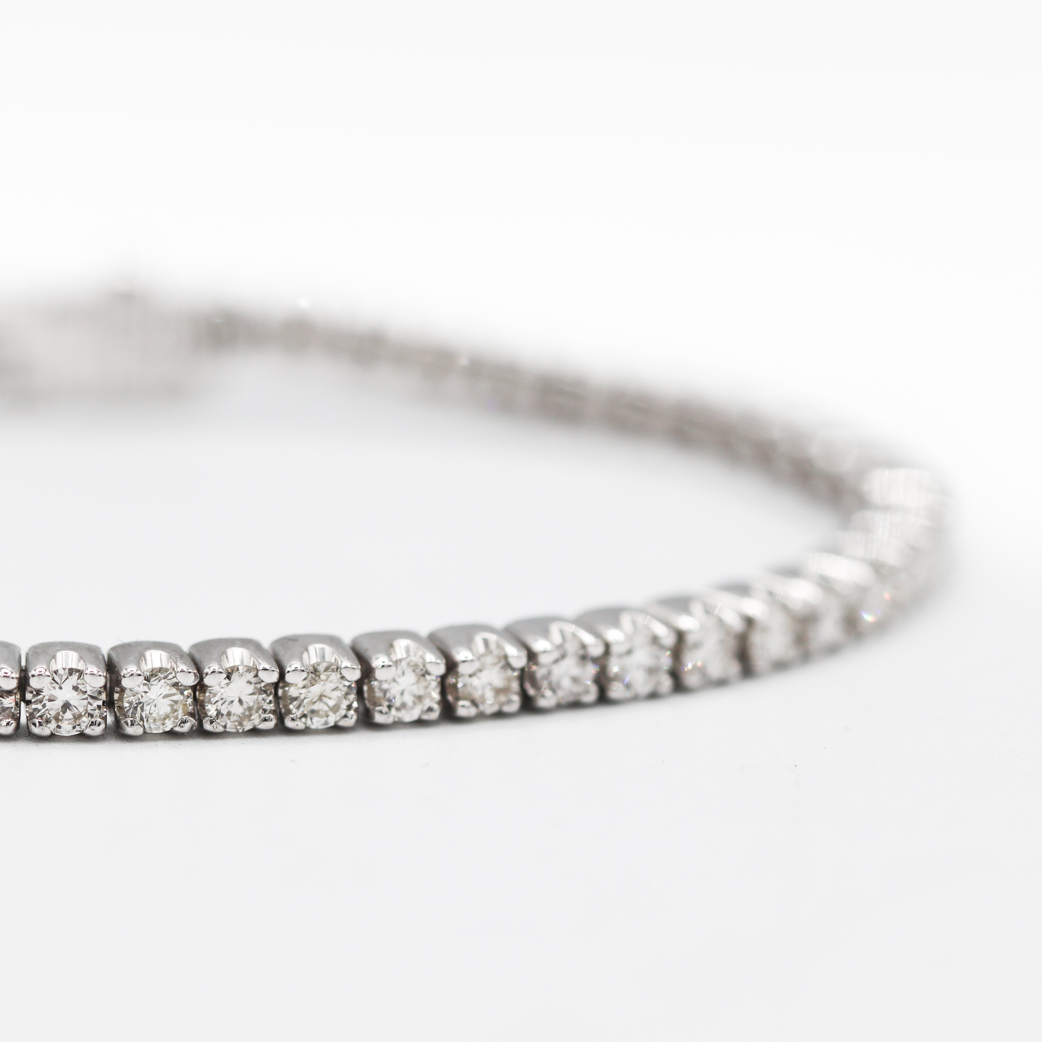 Zoomed in view showing the diamonds of this 14K White Gold 4 carat total weight natural diamond tennis bracelet on a white background.
