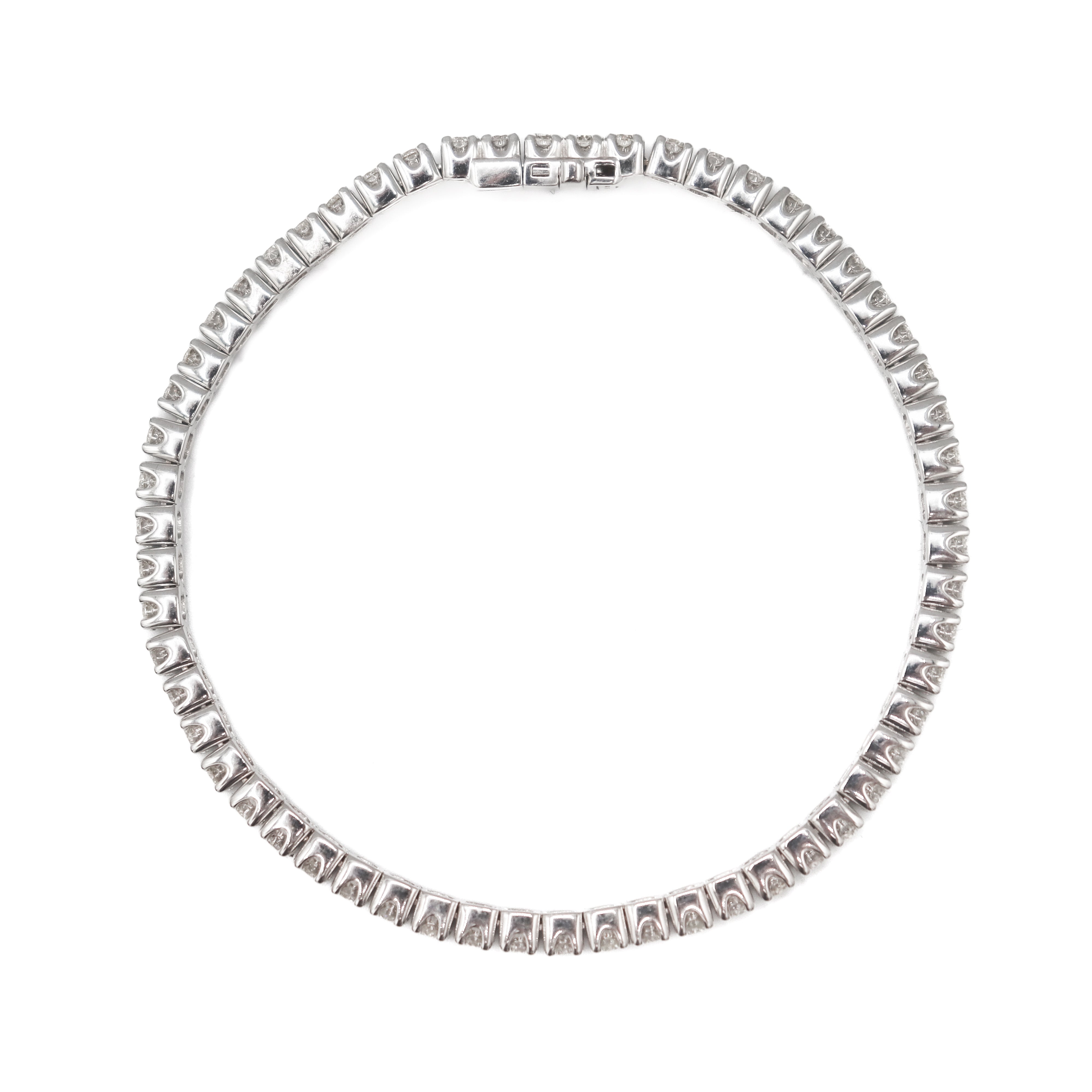 Side view showing the links of this 14K White Gold 4 carat total weight natural diamond tennis bracelet on a white background.