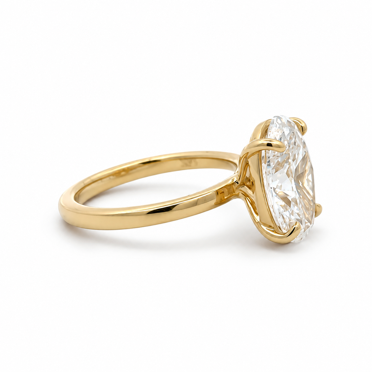 Side view of the Mia 14K yellow gold 5.02CT. oval lab-grown diamond solitaire ring, showing the gallery rail and polished band.