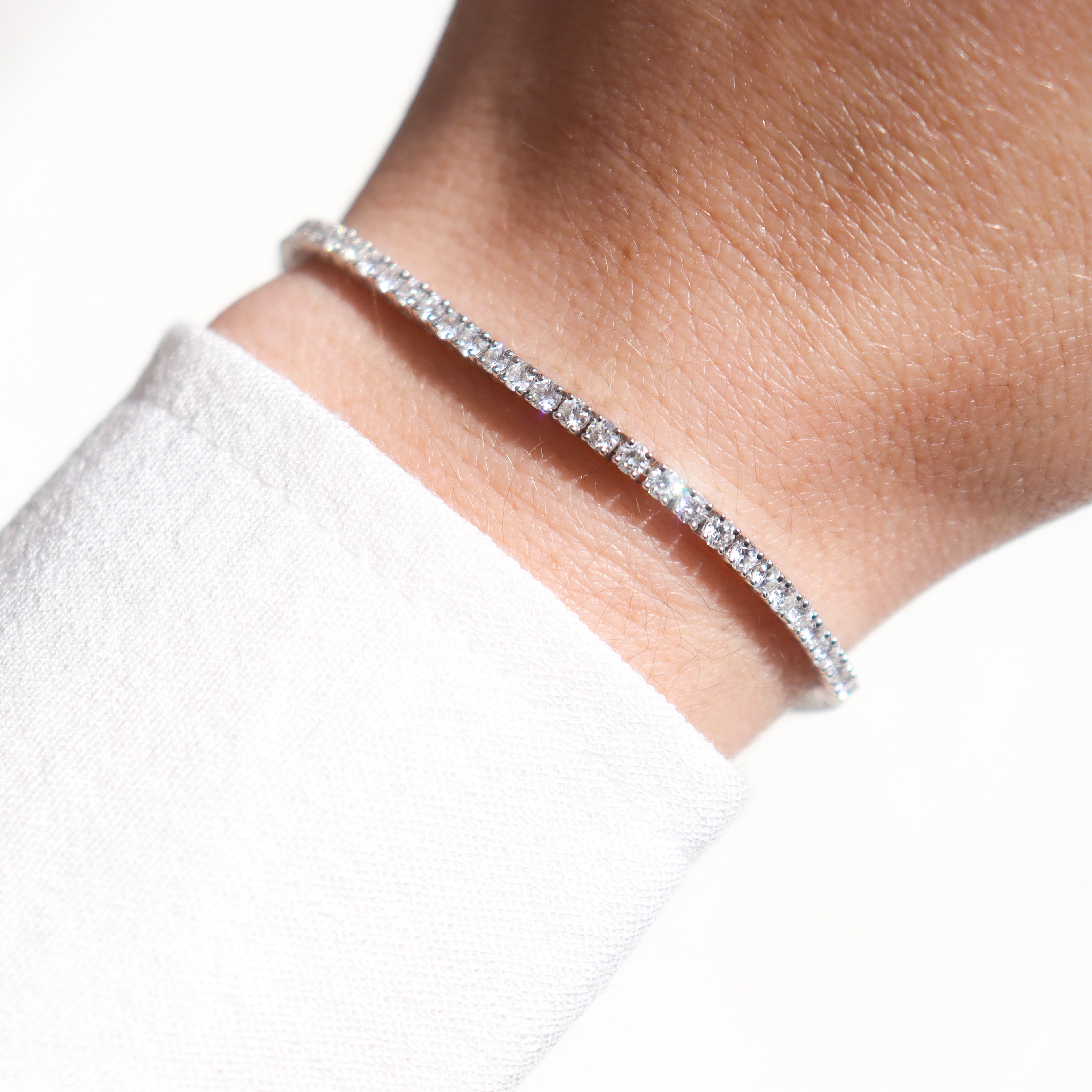 14K White Gold 3CTW. Lab-Grown Diamond Tennis Bracelet on a model's wrist.