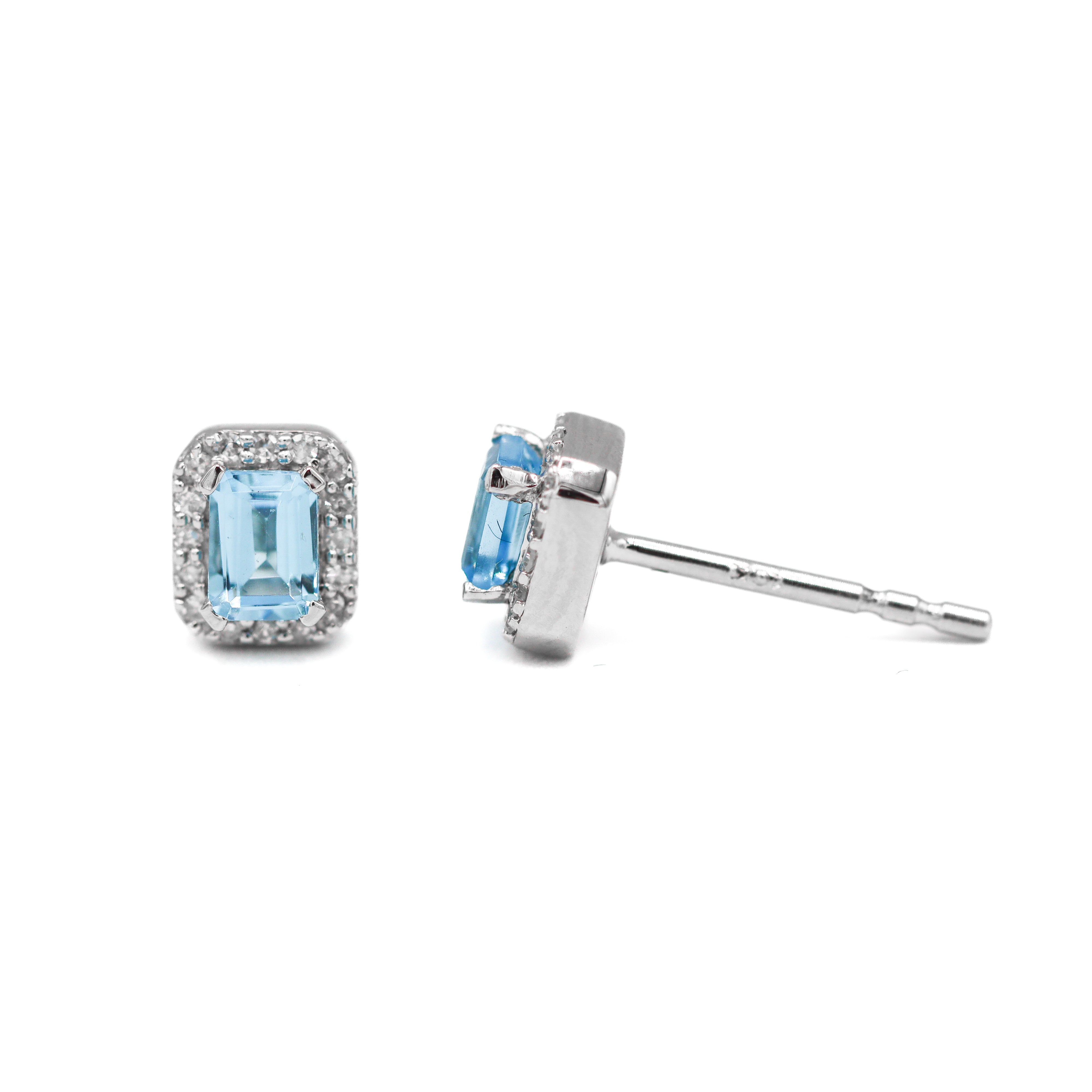 Left front-facing view and right side view of 10K White Gold Emerald-Cut Swiss Blue Topaz & 1/10CT. Diamond Halo Stud Earrings on a white background.